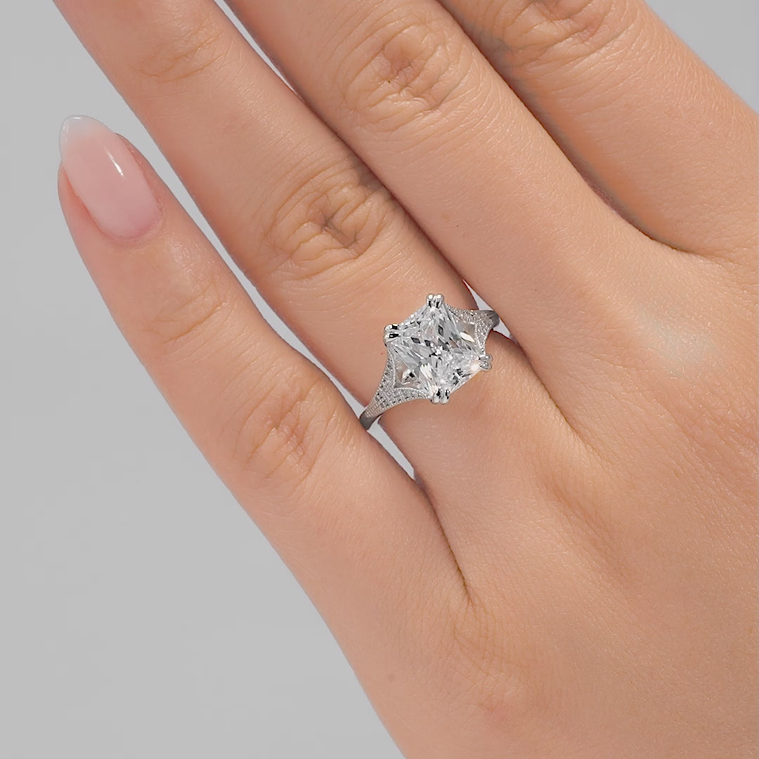 video of a vintage silver 3 carat radiant cut engagement ring with a stone adorned split shank detail on a model