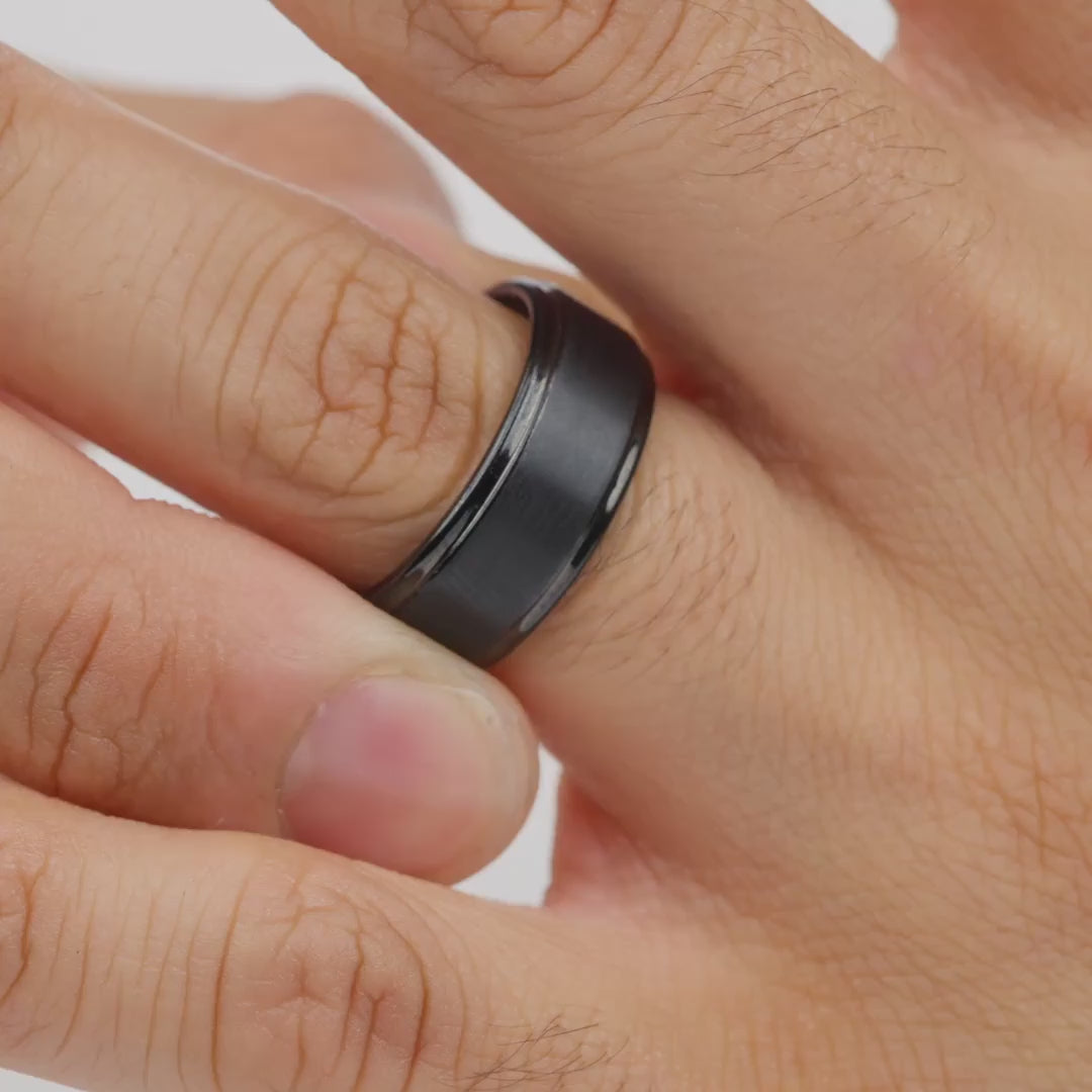 video of a black tungsten carbide wedding band worn by model