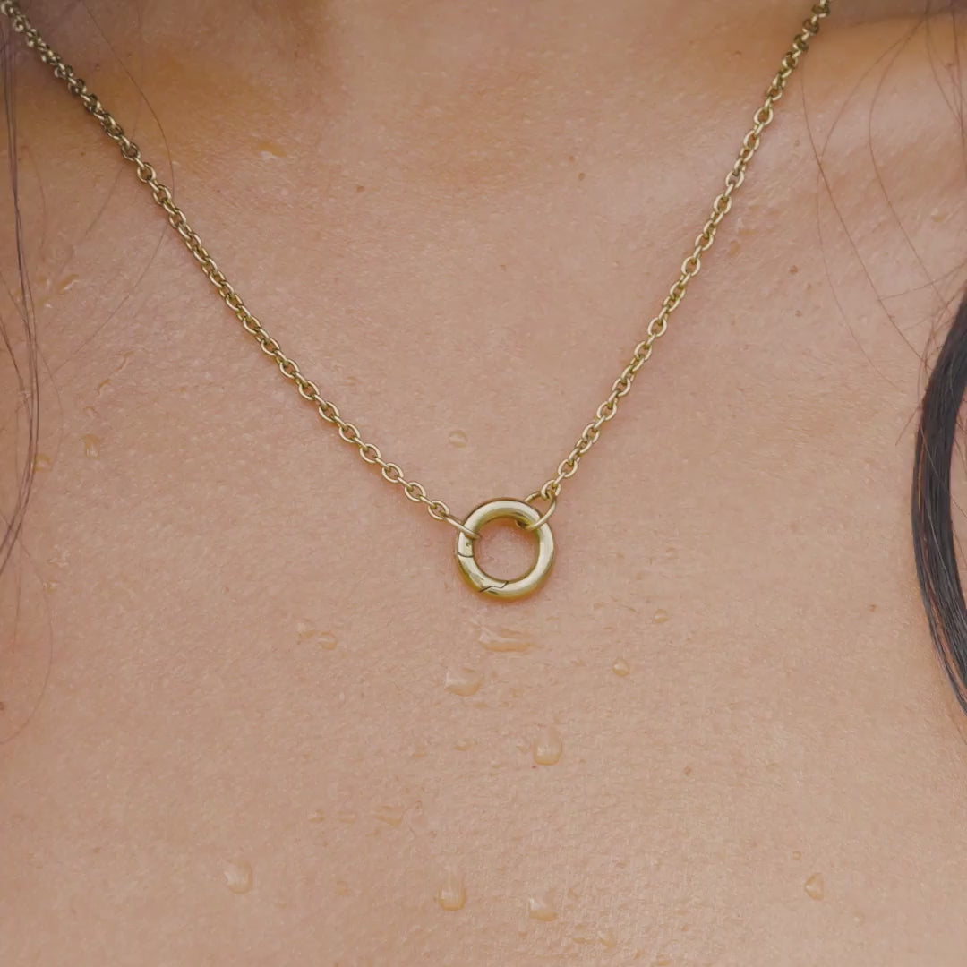 video of a 14k gold PVD plated stainless steel charm necklace worn by a model at the pool