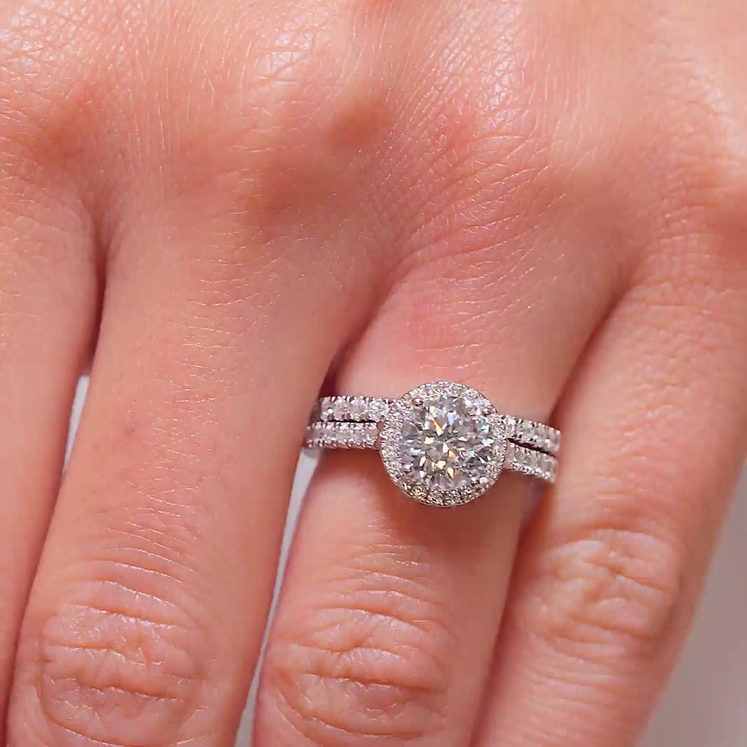 video of a silver, stunning halo round cut half eternity wedding ring set on a model