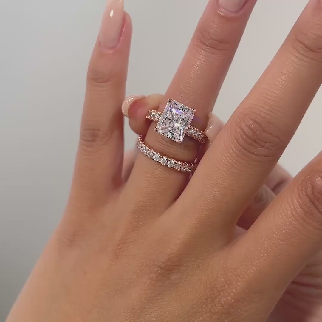 video of rose gold radiant cut wedding ring set on model with neutral nails