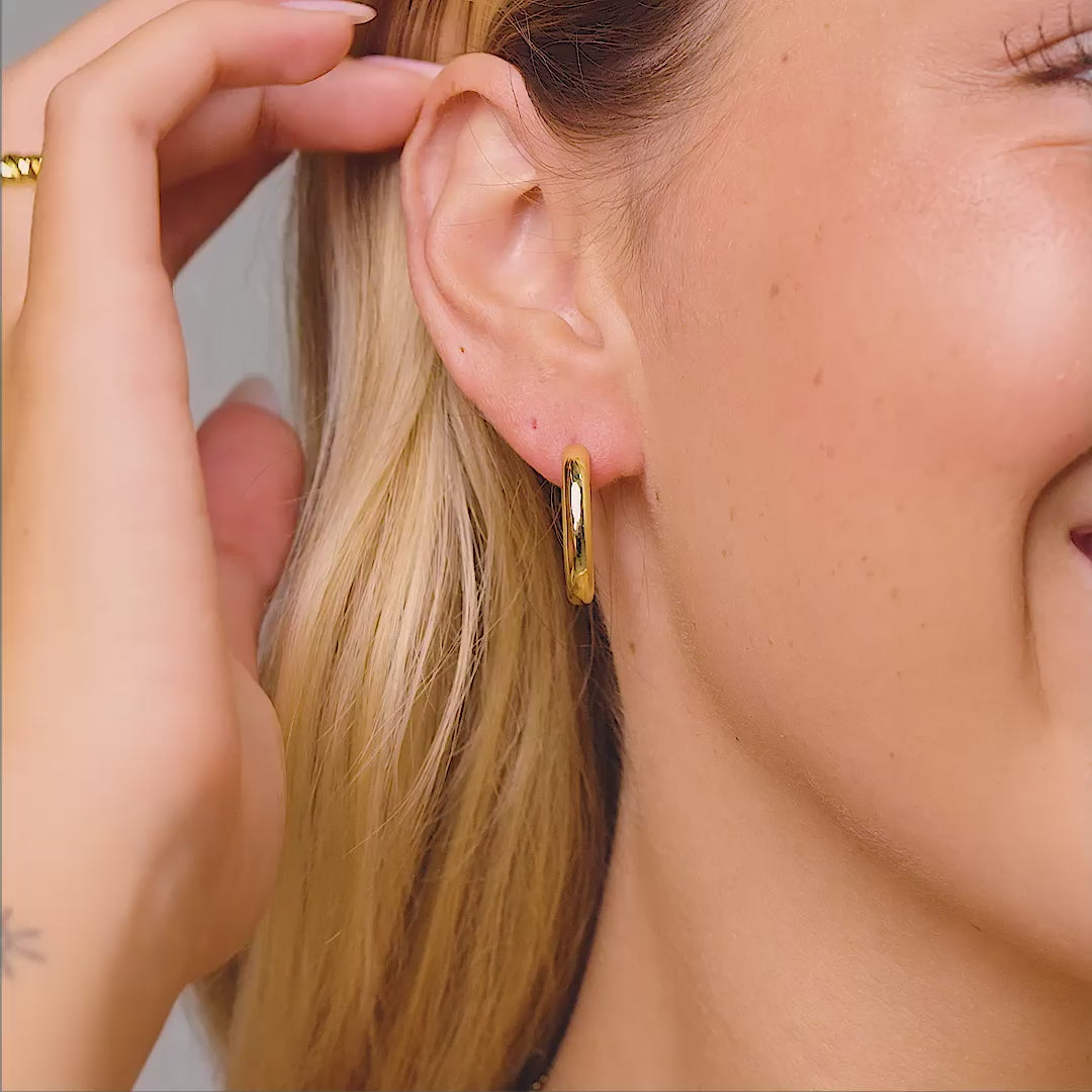 bold hoop earrings on model in gold