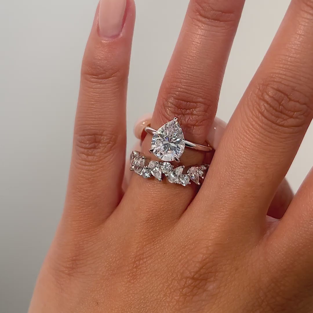 video of silver 3 carat pear cut wedding ring set on model
