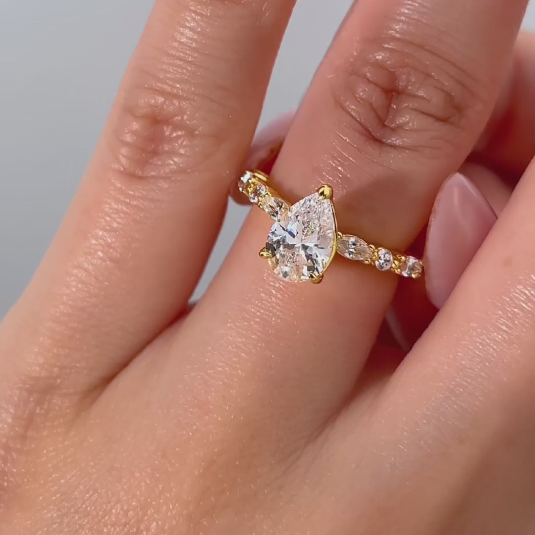 video of gold 1.5 pear cut vintage engagement ring on female model
