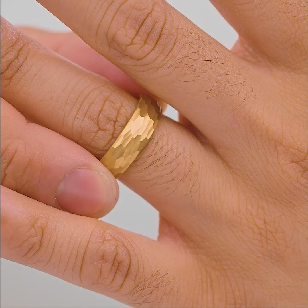 mens hammer gold affordable wedding ring on hand in studio setting