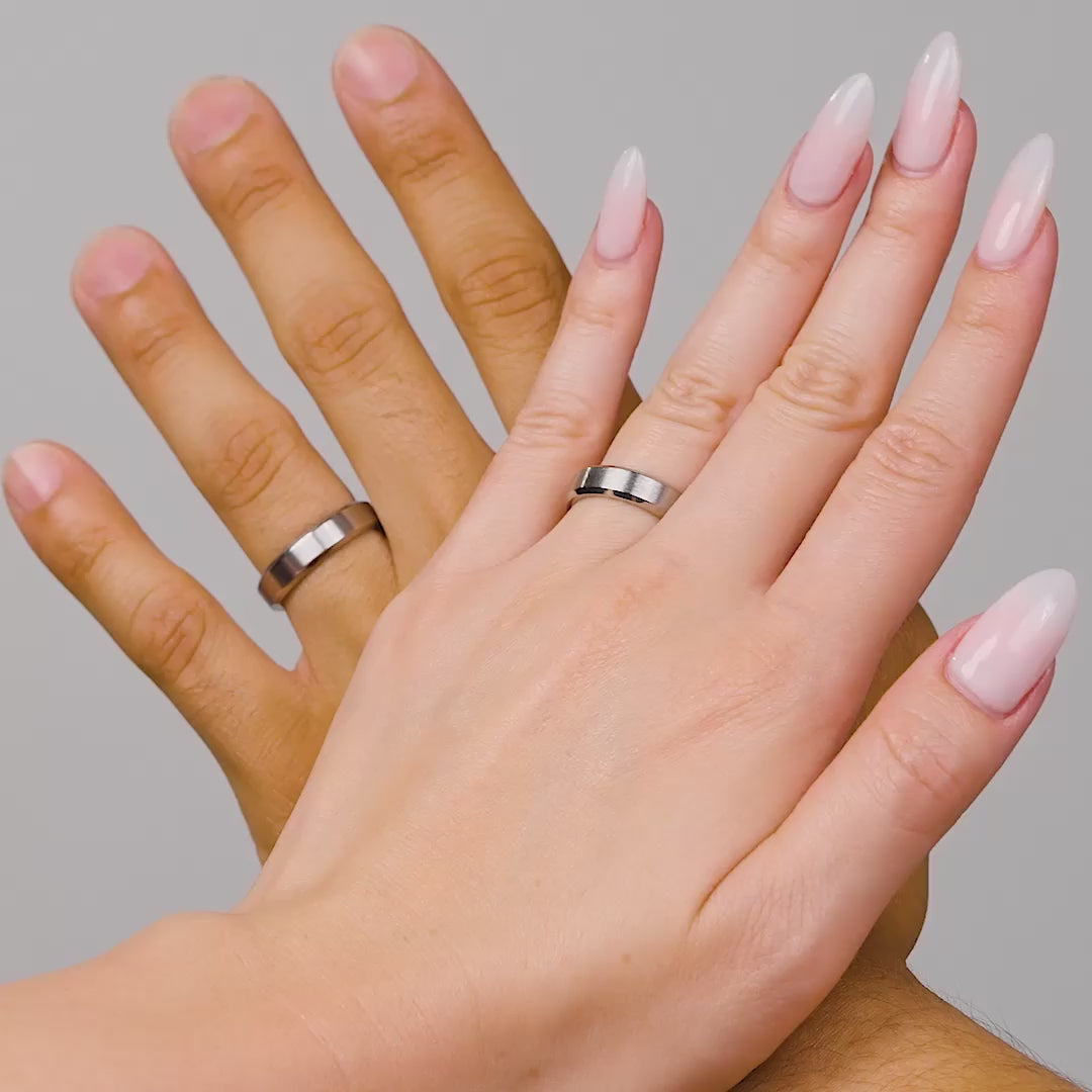 silver slim unisex titanium steel wedding band shown on both a male and female model