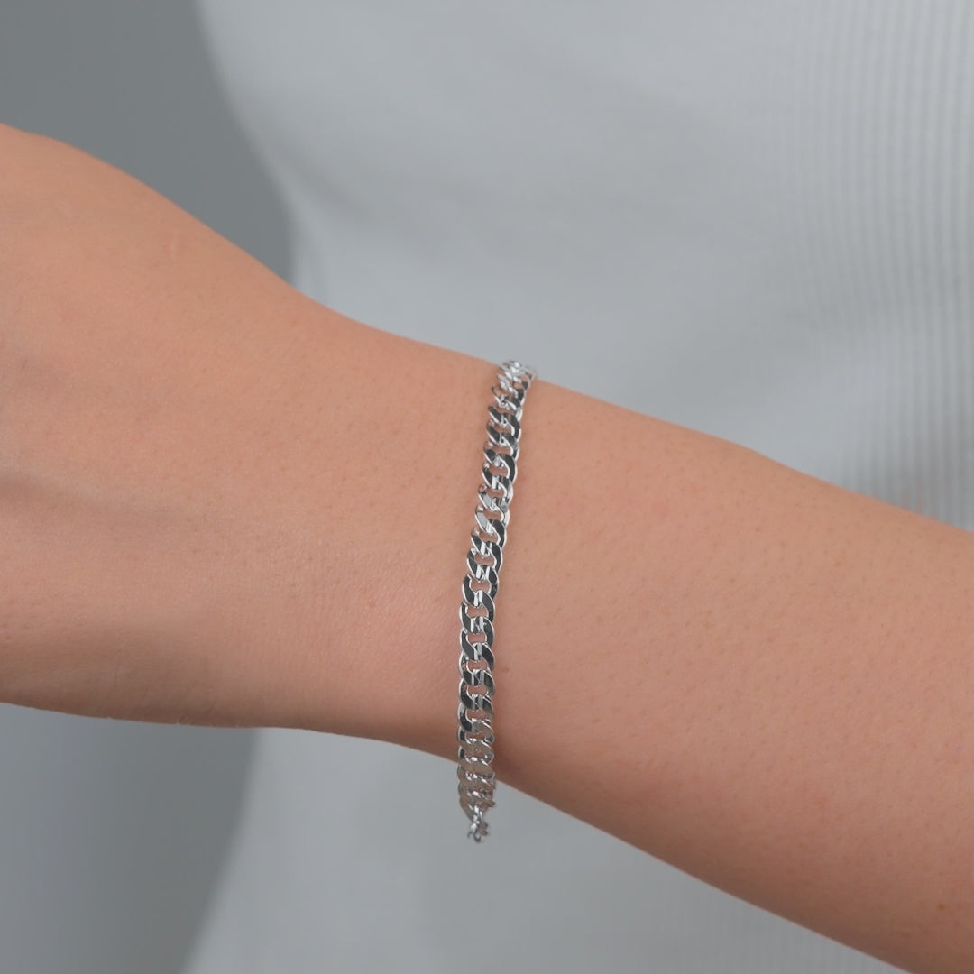 video of a silver cuban link chain bracelet on a model