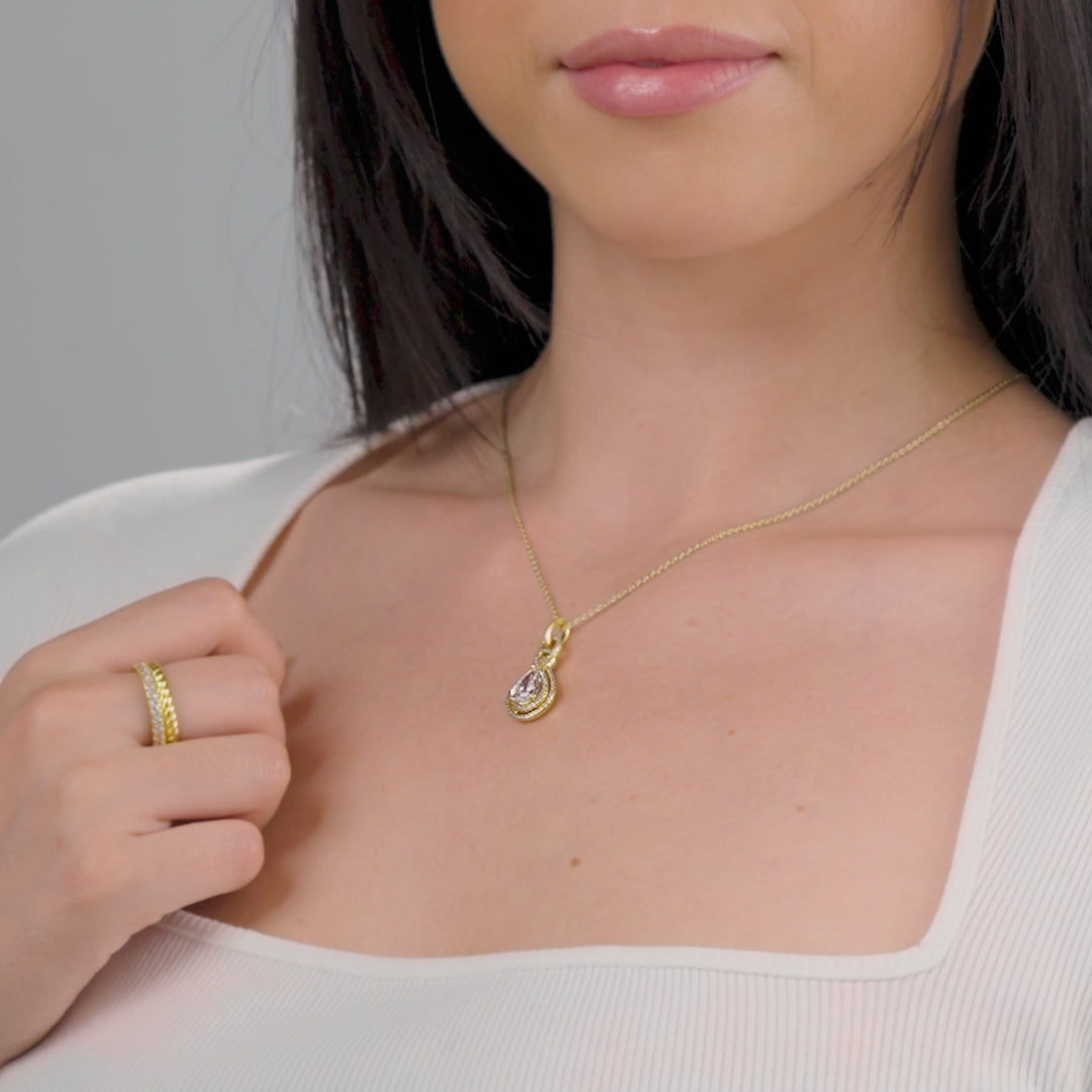 video of unqiue gold pear cut bridal necklace with intricate stone detailing on female model