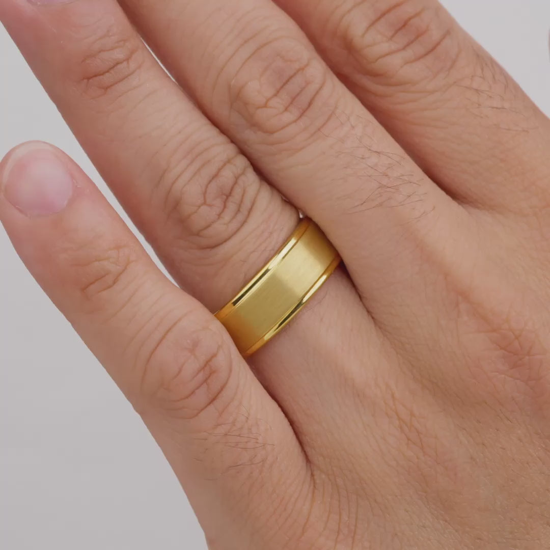video of a gold tungsten carbide wedding band worn by model
