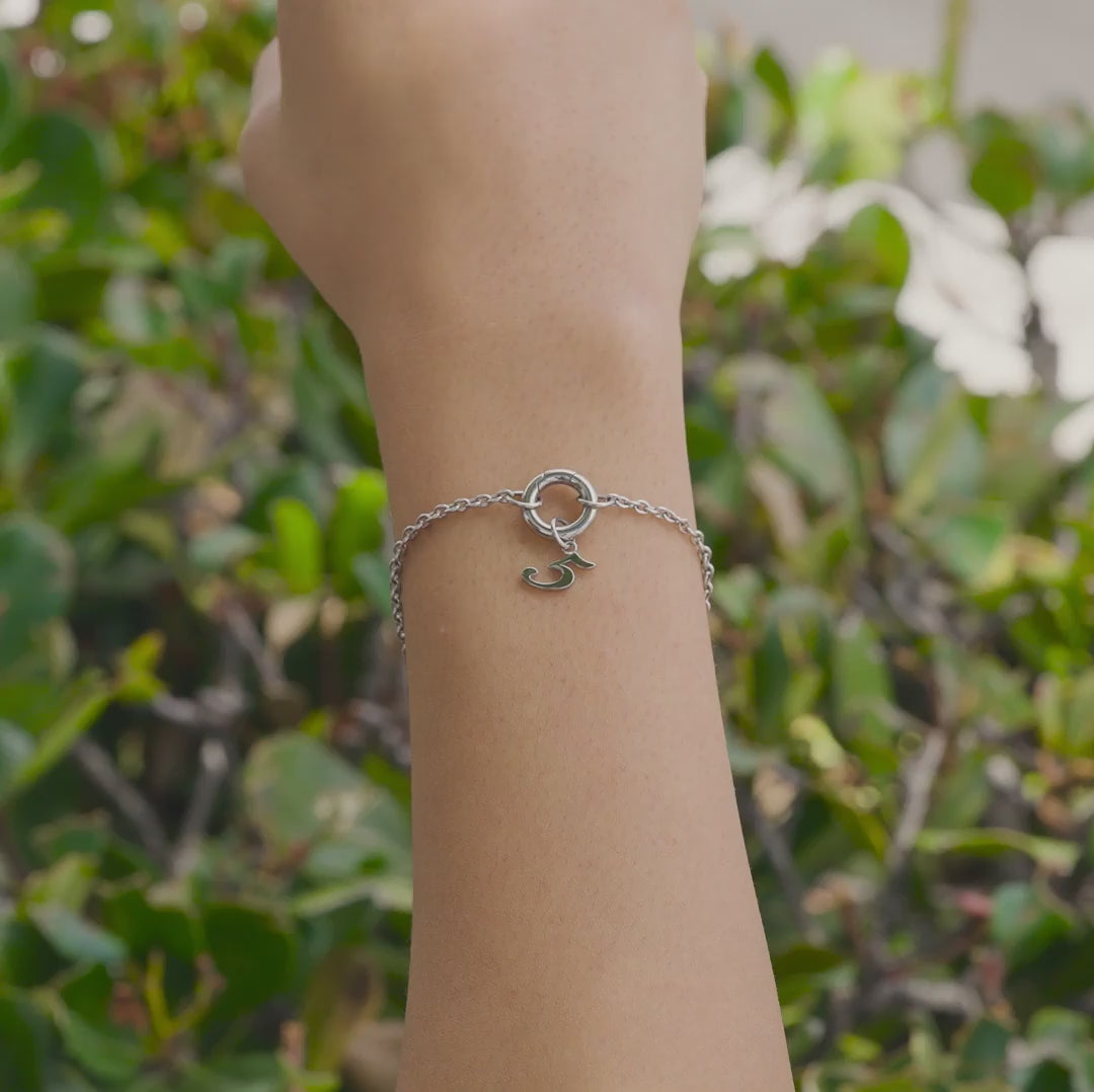 Silver Stainless Steel Charm Bracelet with Silver Number Charm in "5" worn by model who is outside