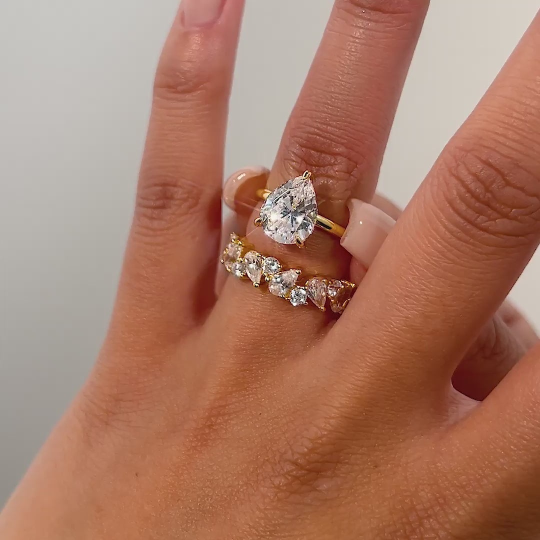 video of gold 3 carat pear cut wedding ring set on model