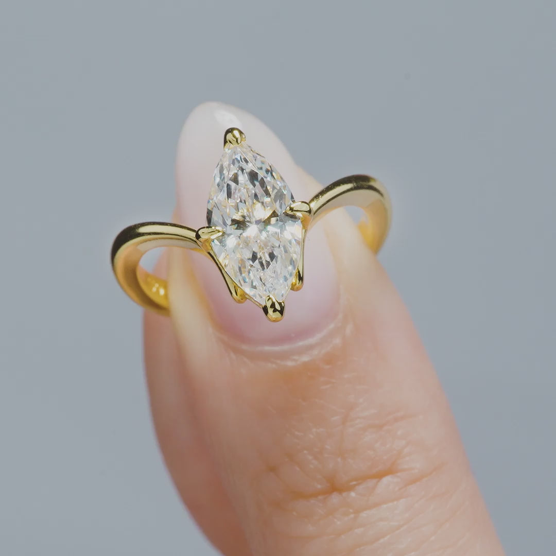 video of gold 2 carat marquise solitaire chevron engagement ring on a model