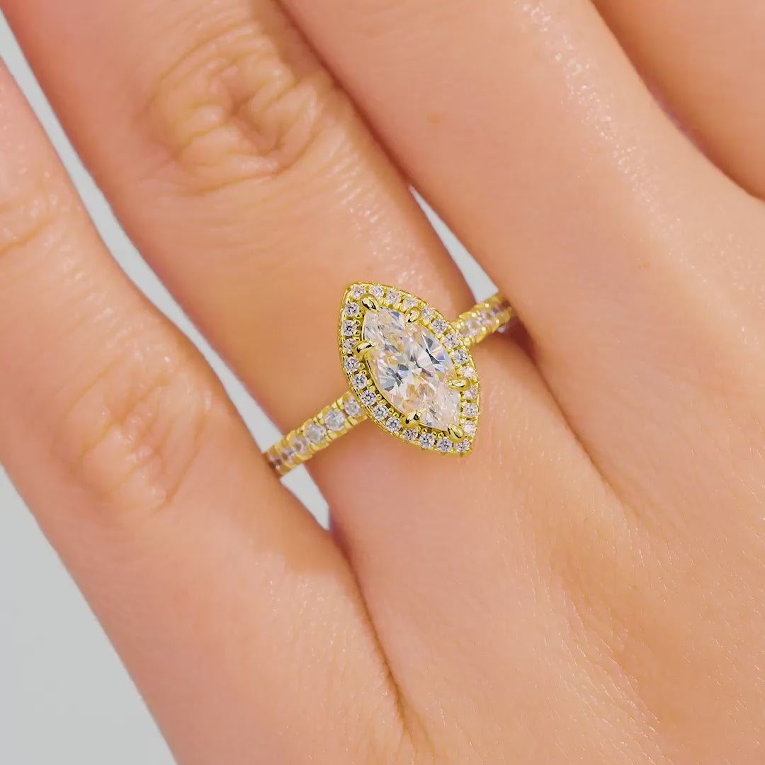 video of 1 carat halo marquise engagement ring with half eternity band detail on female model