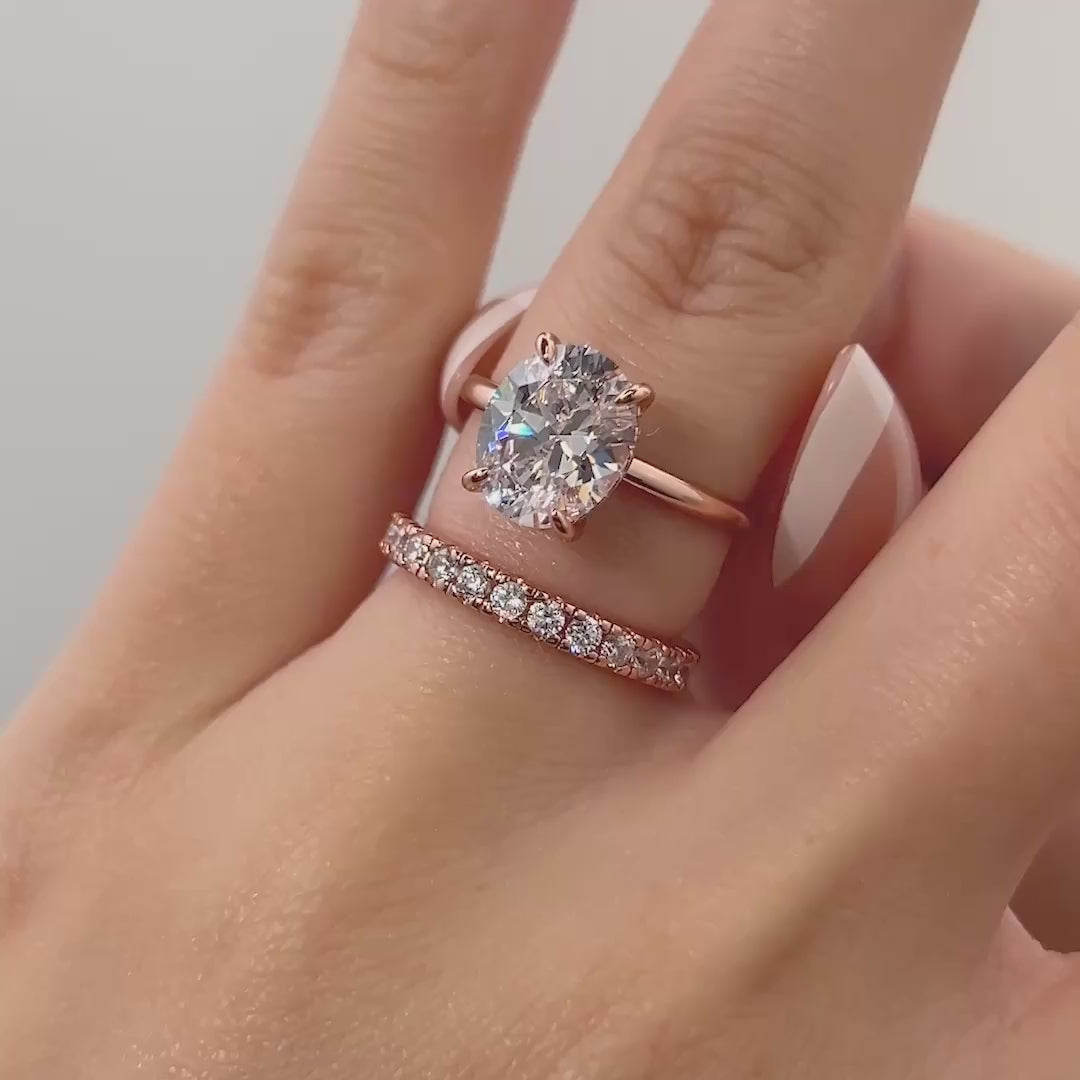 video of classic rose gold 3 carat oval cut wedding ring set on model with french tip nails