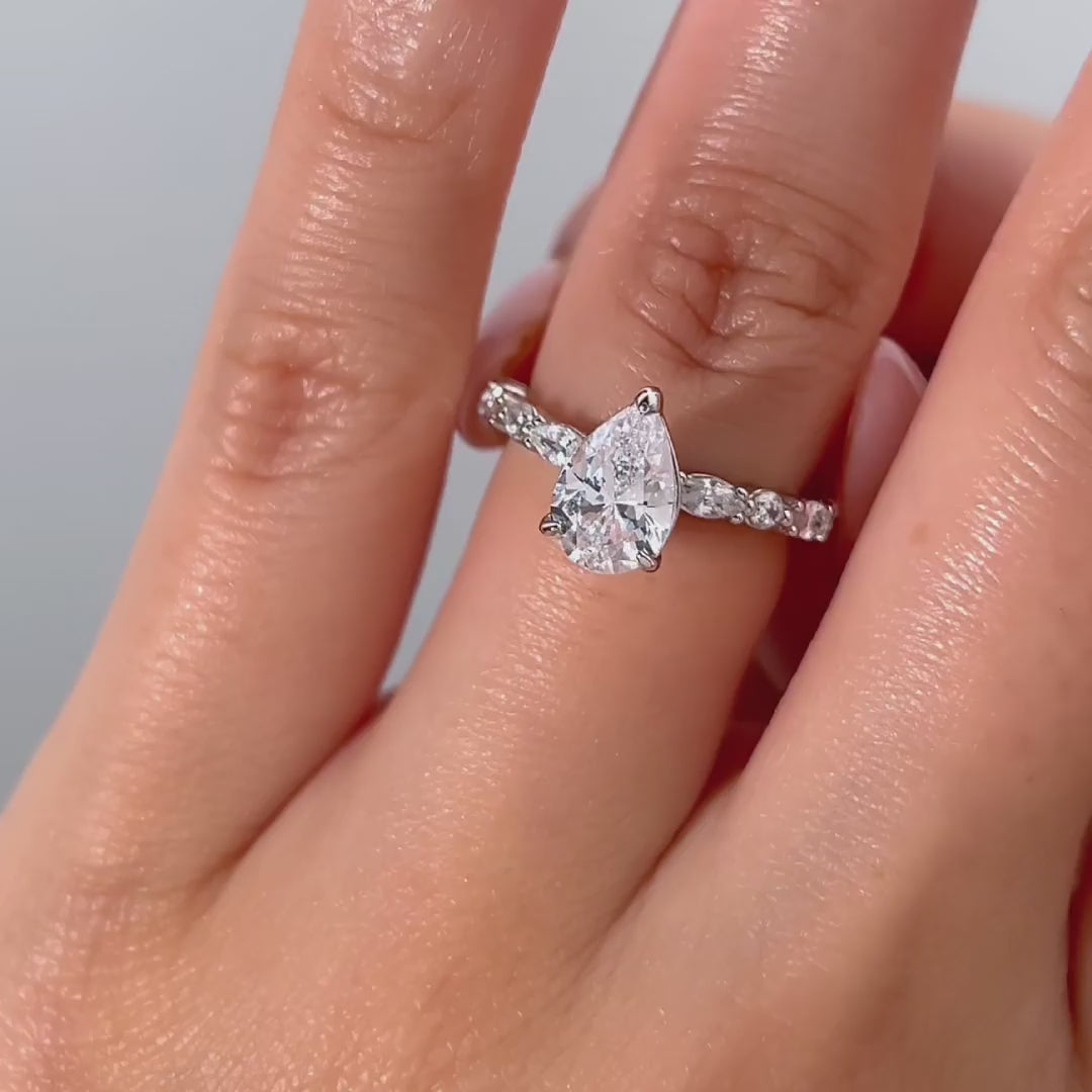 video of silver 1.5 pear cut vintage engagement ring on female model