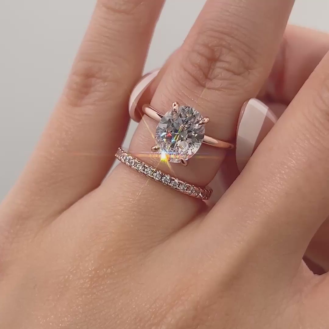 video of classic rose gold 3 carat oval cut wedding ring set shown on model