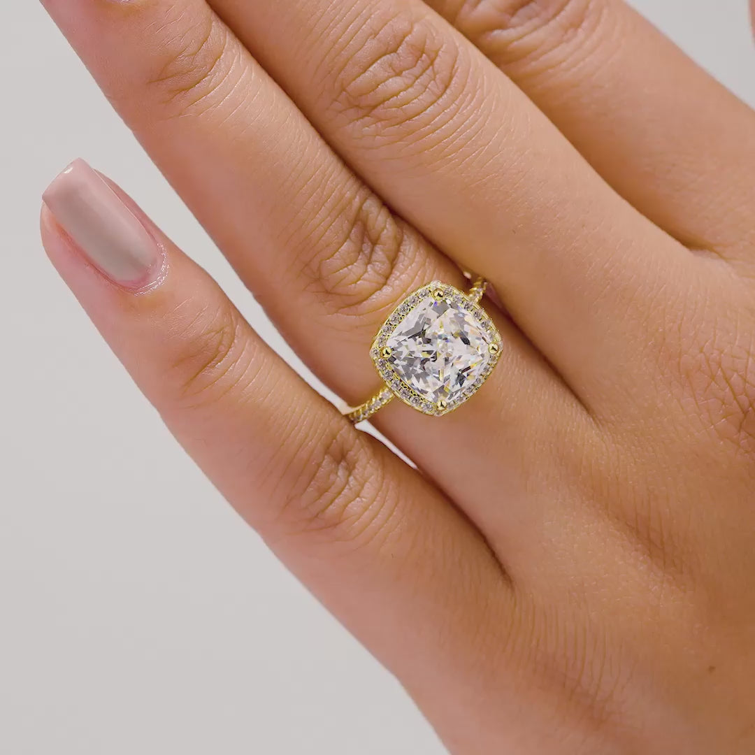 video of gold 3 carat cushion cut halo engagement ring on model