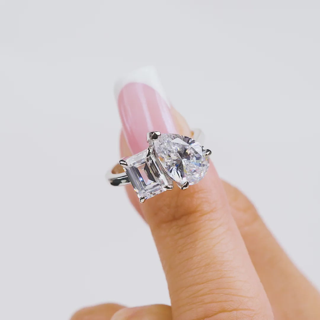 video of silver toi et moi engagement ring on model with french tip nails