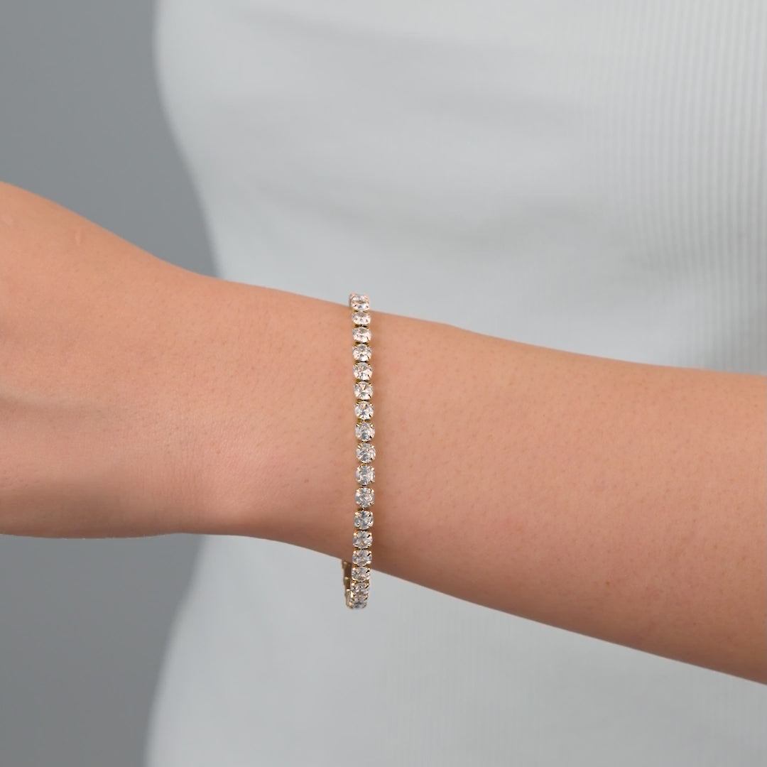 video of a stunning gold tennis bracelet on a model