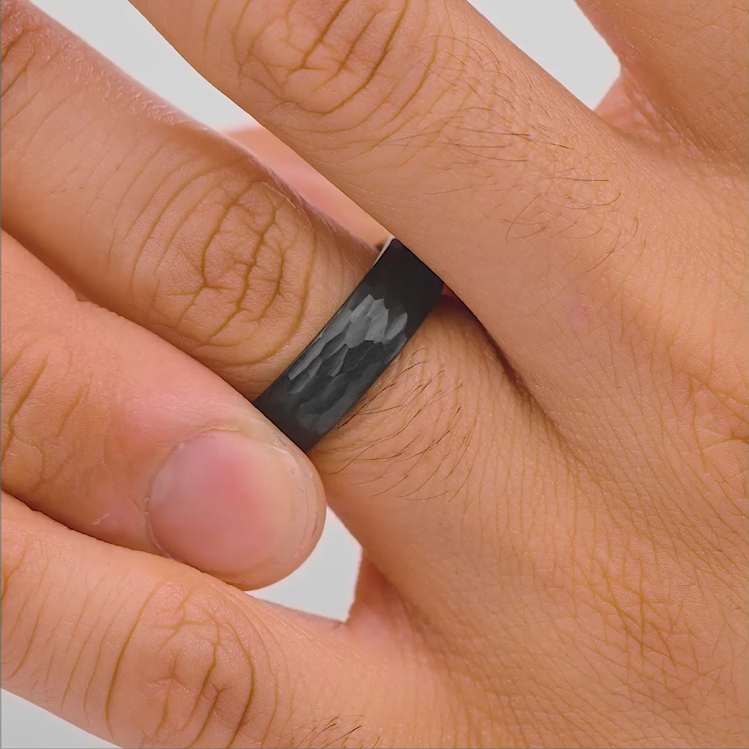 video of black wedding band shown on male model's hand