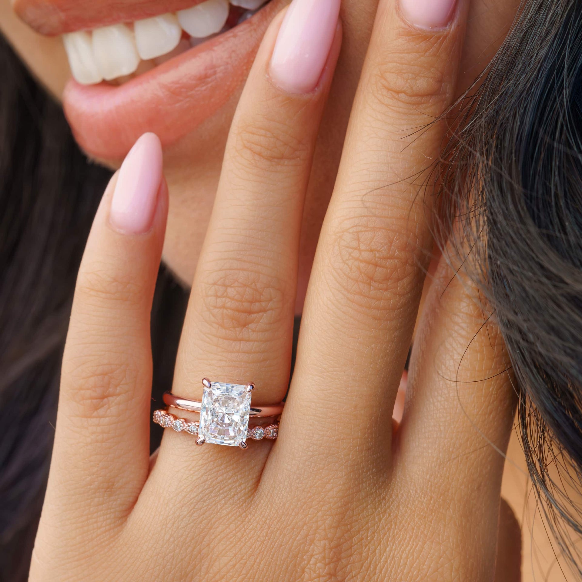 woman wearing rose gold vintage wedding band with radiant cut engagement ring