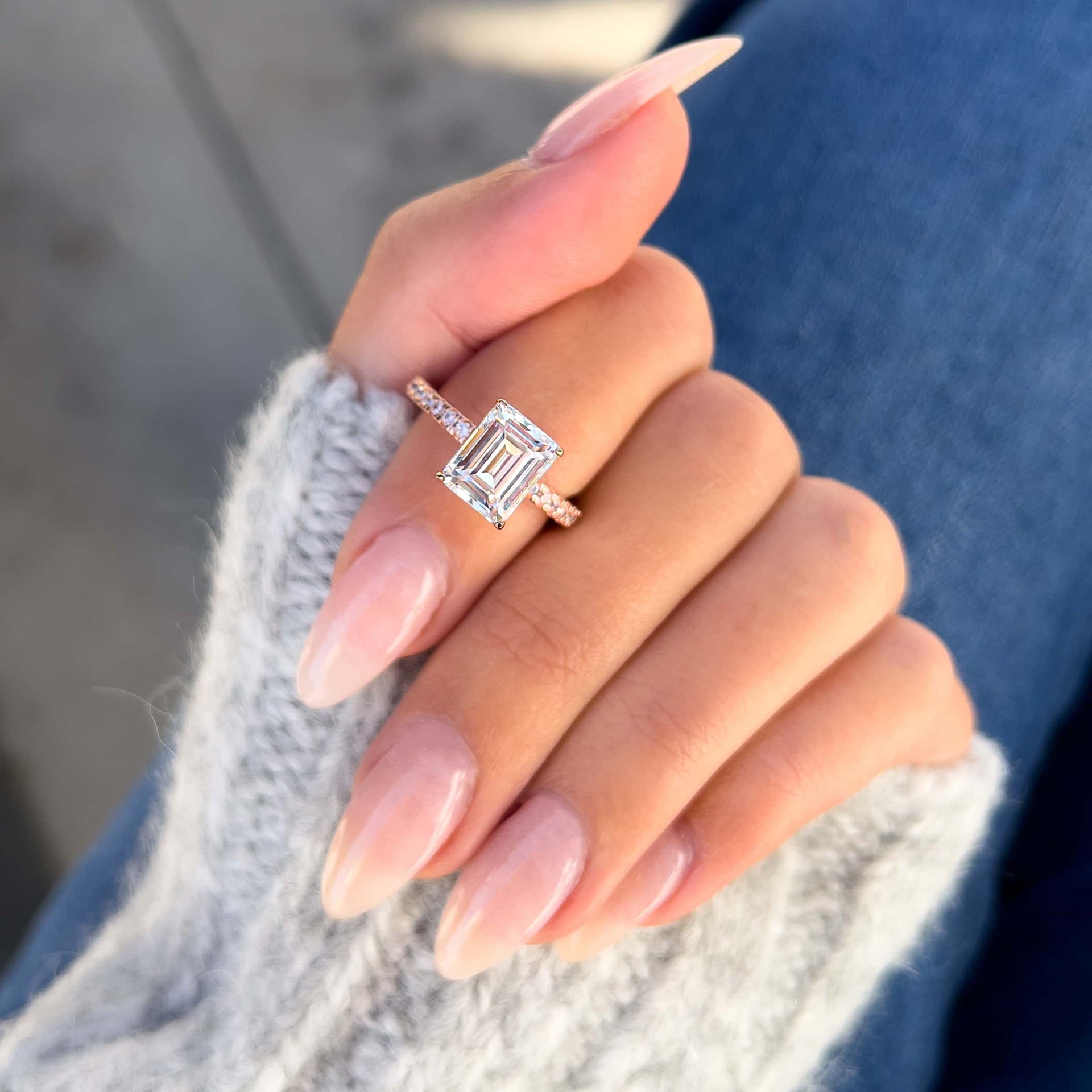 stunning emerald cut rose gold ring on model's finger