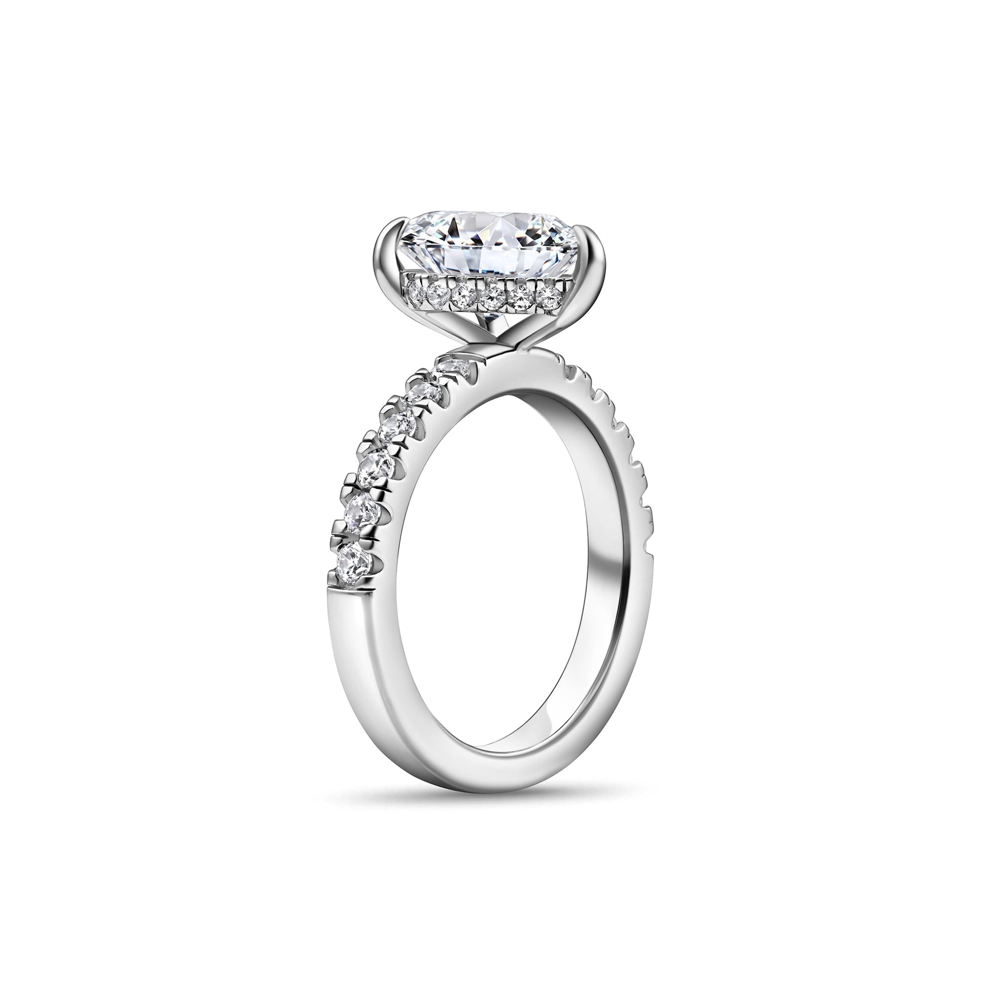 side view of silver pear cut engagement ring with half eternity engagement ring with hidden halo detailing