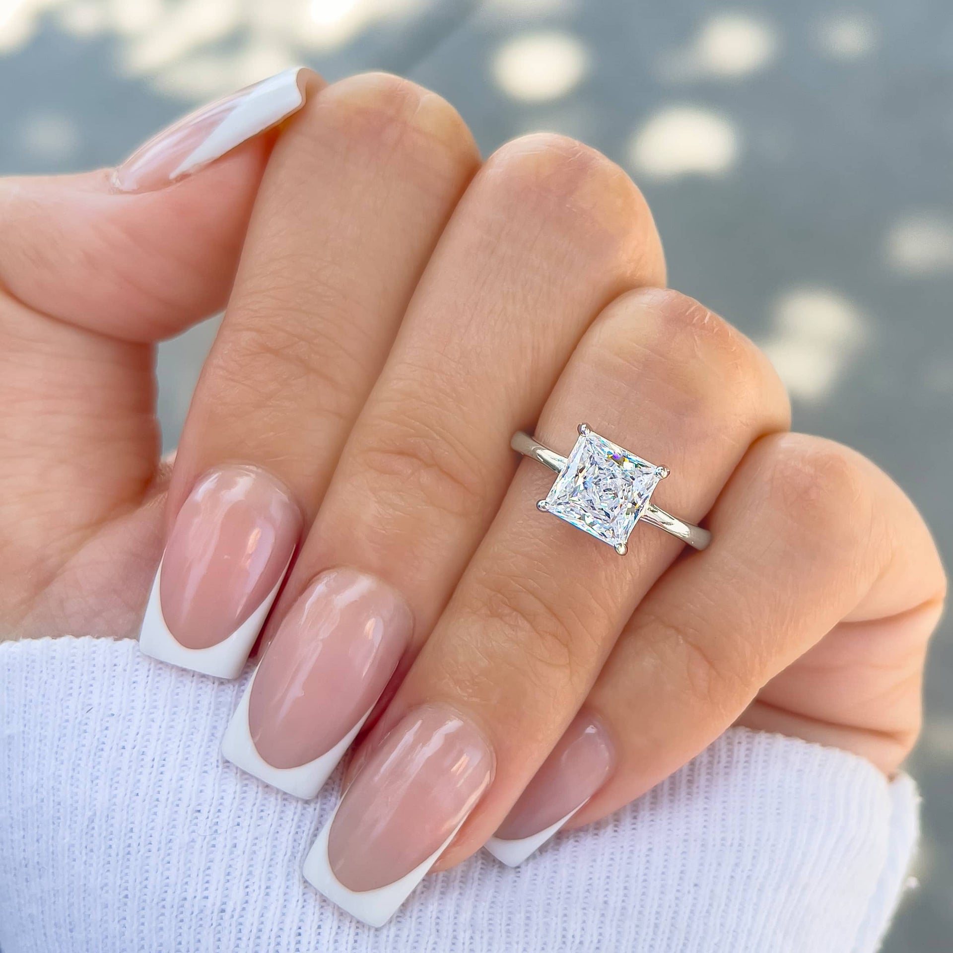 2 carat princess cut solitaire on hand with french tip nails