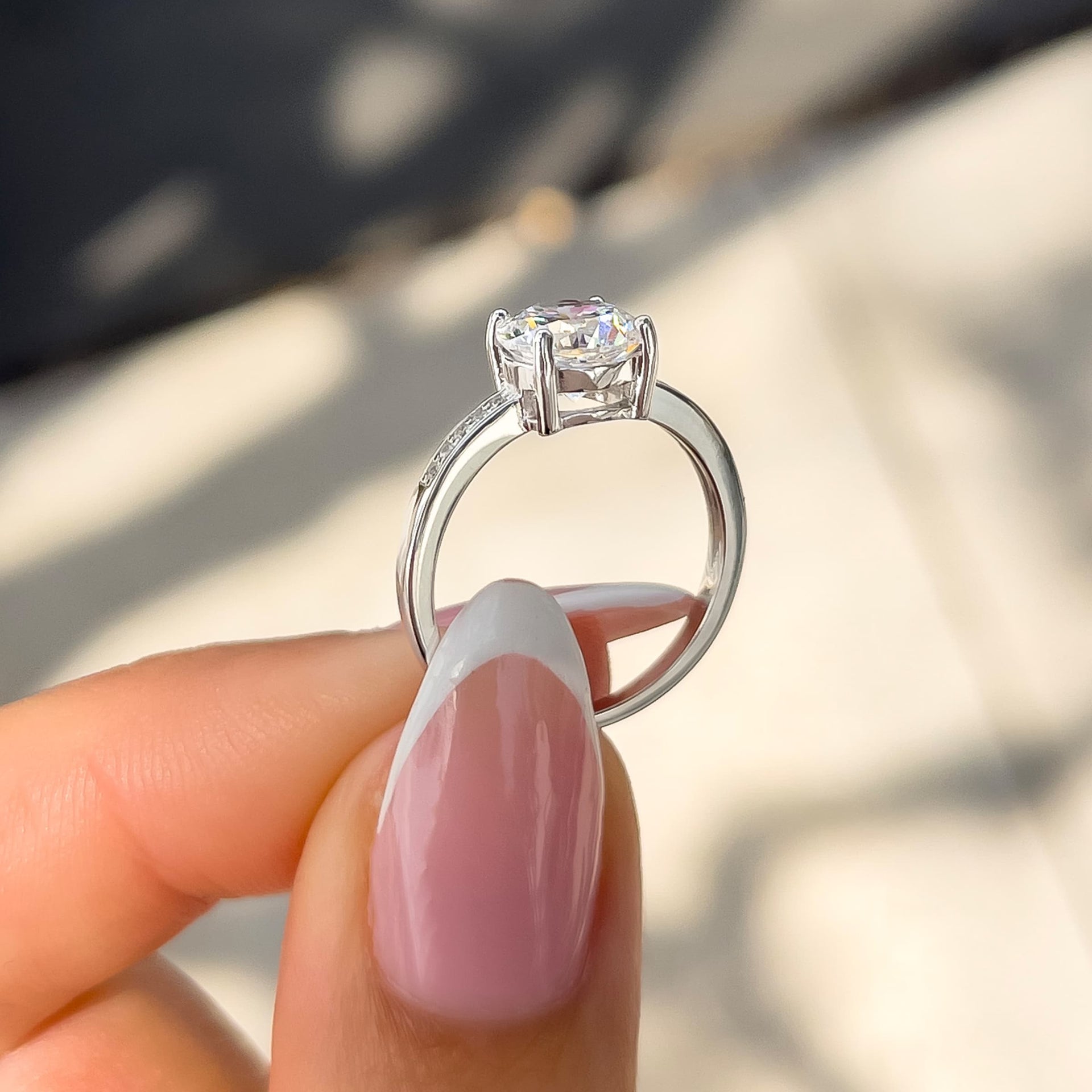 side view of classic silver round cut engagement ring