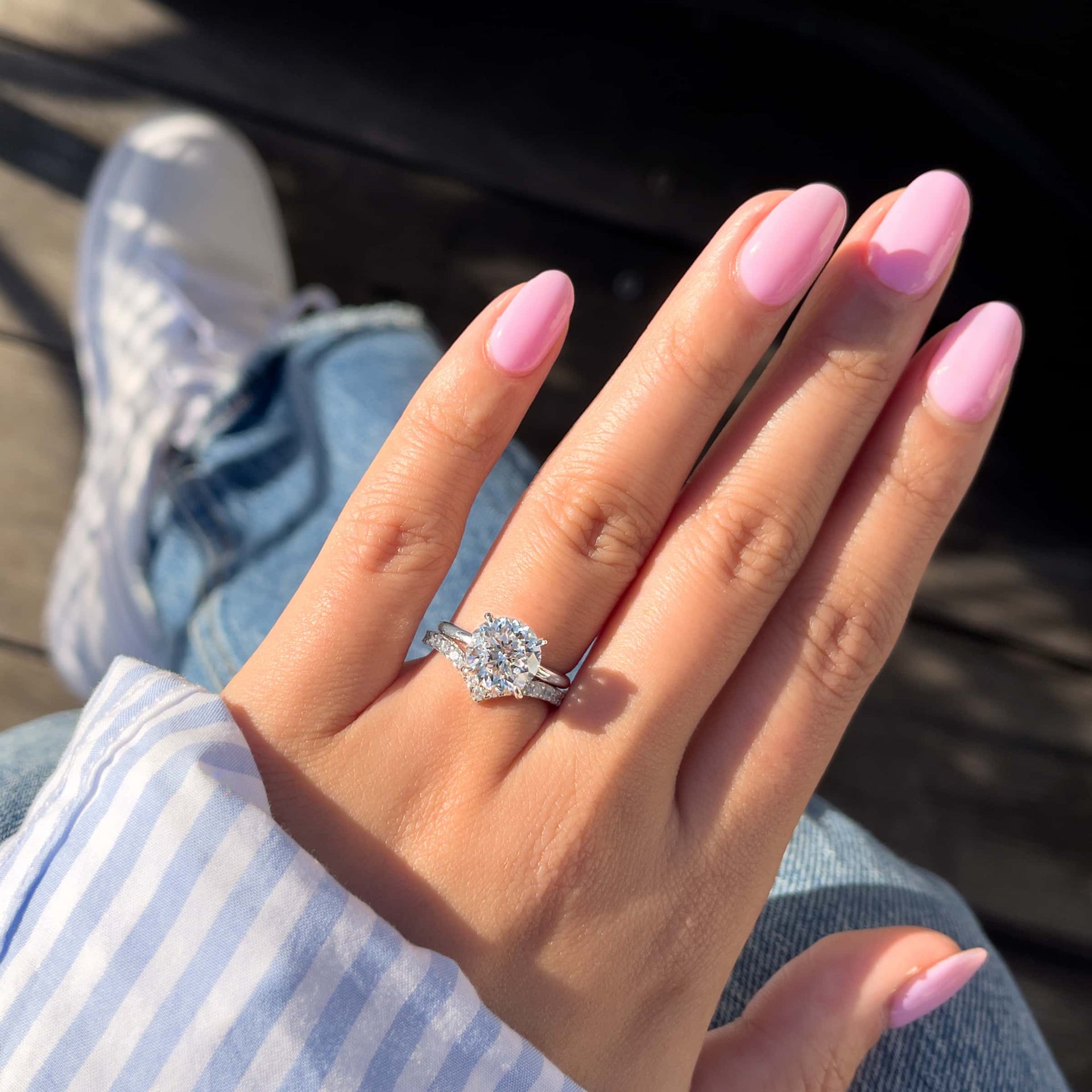 silver round engagement ring in silver on ladies hand