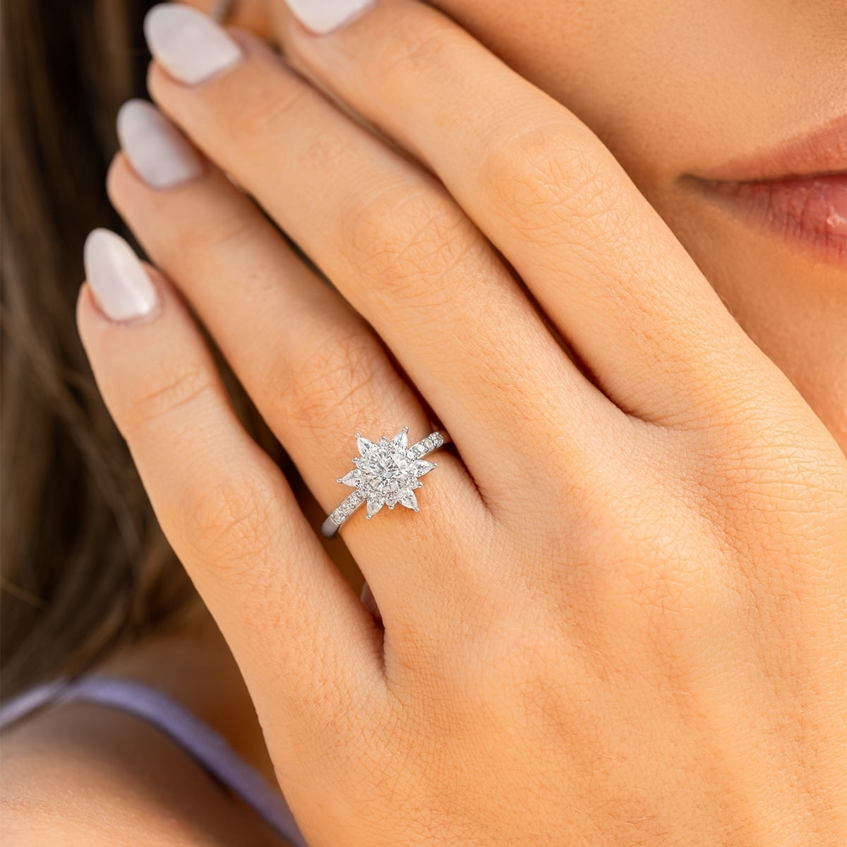 Stunning silver engagement ring with round cut diamond and pear halo.