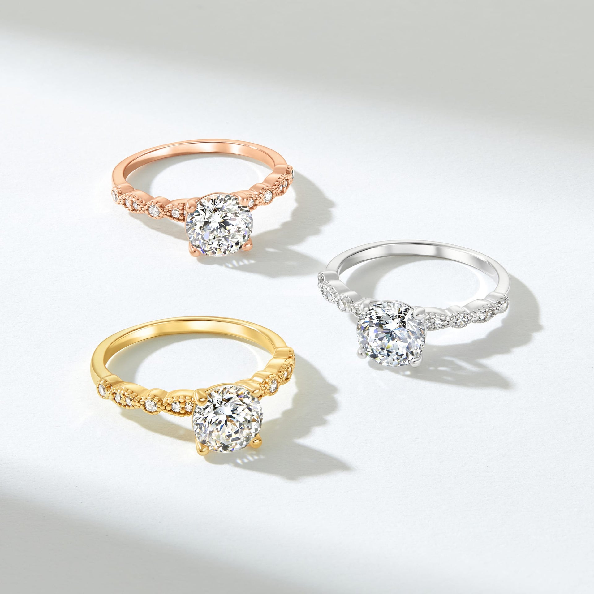 silver, rose gold, and gold high quality engagement rings on neutral white background