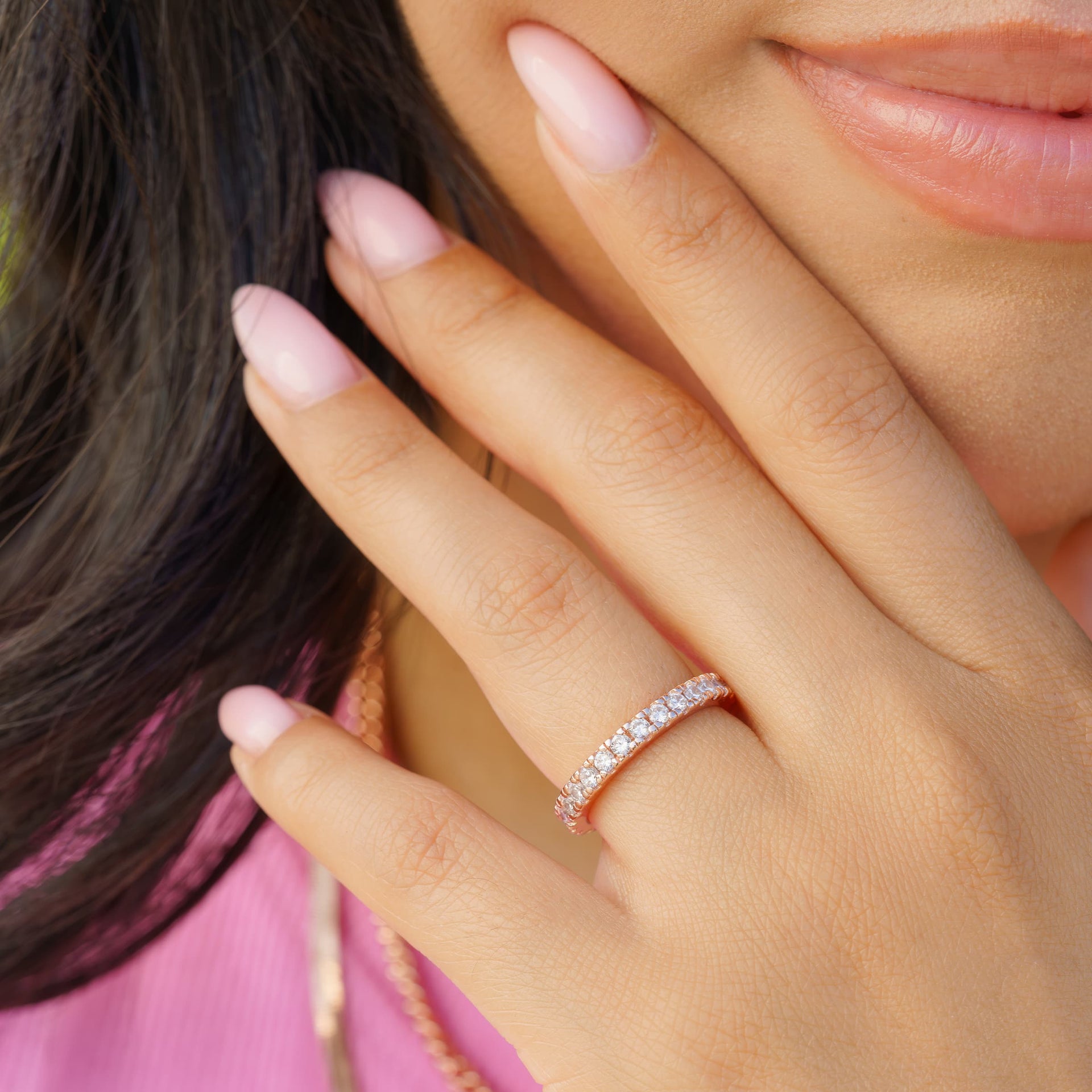 woman wearing rose gold eternity wedding band