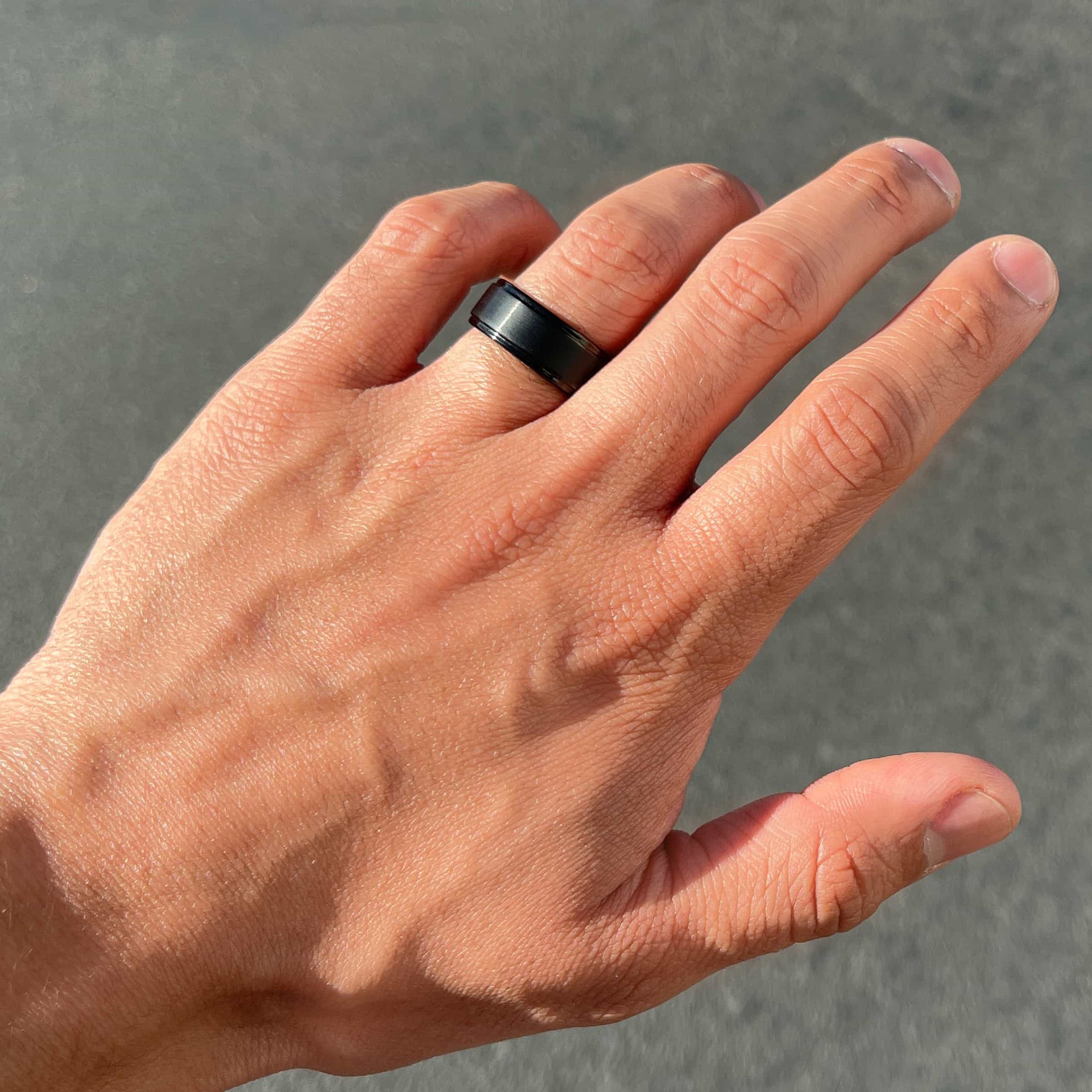 black excalibur wedding band on men's hand