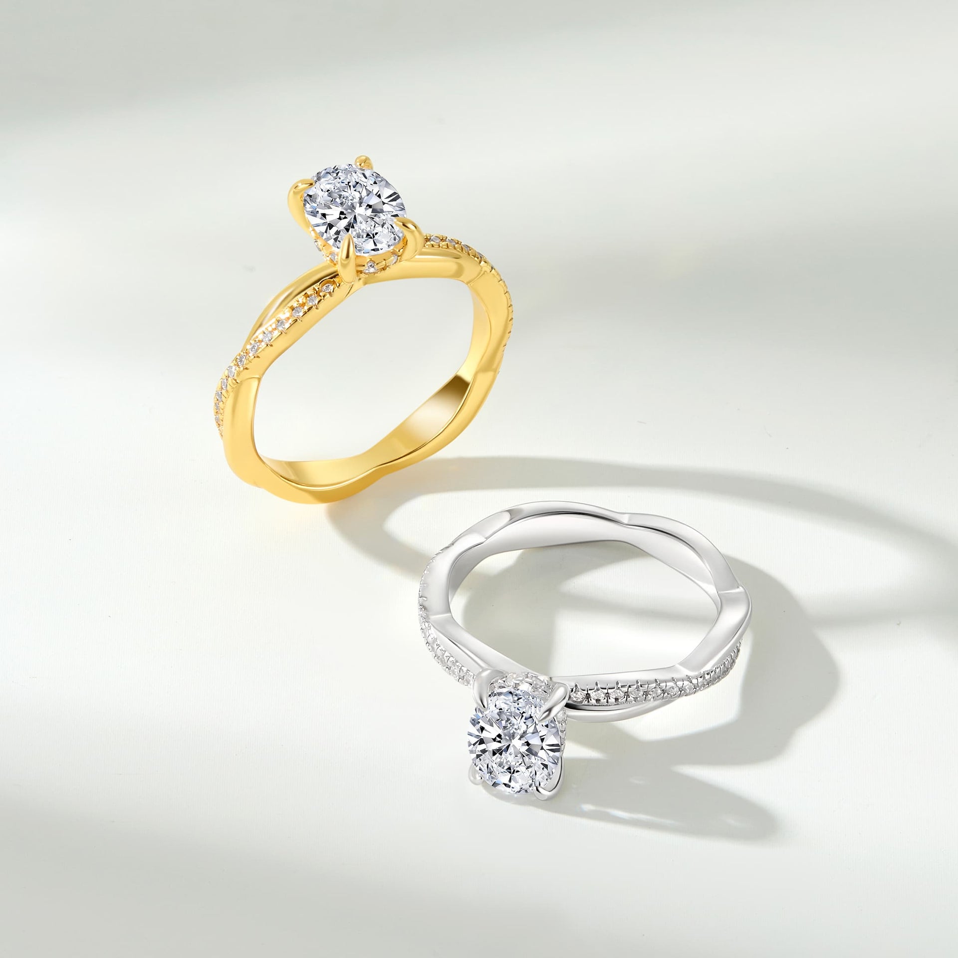 a 1.5 carat oval cut vintage style engagement ring shown in silver and gold on an off white background