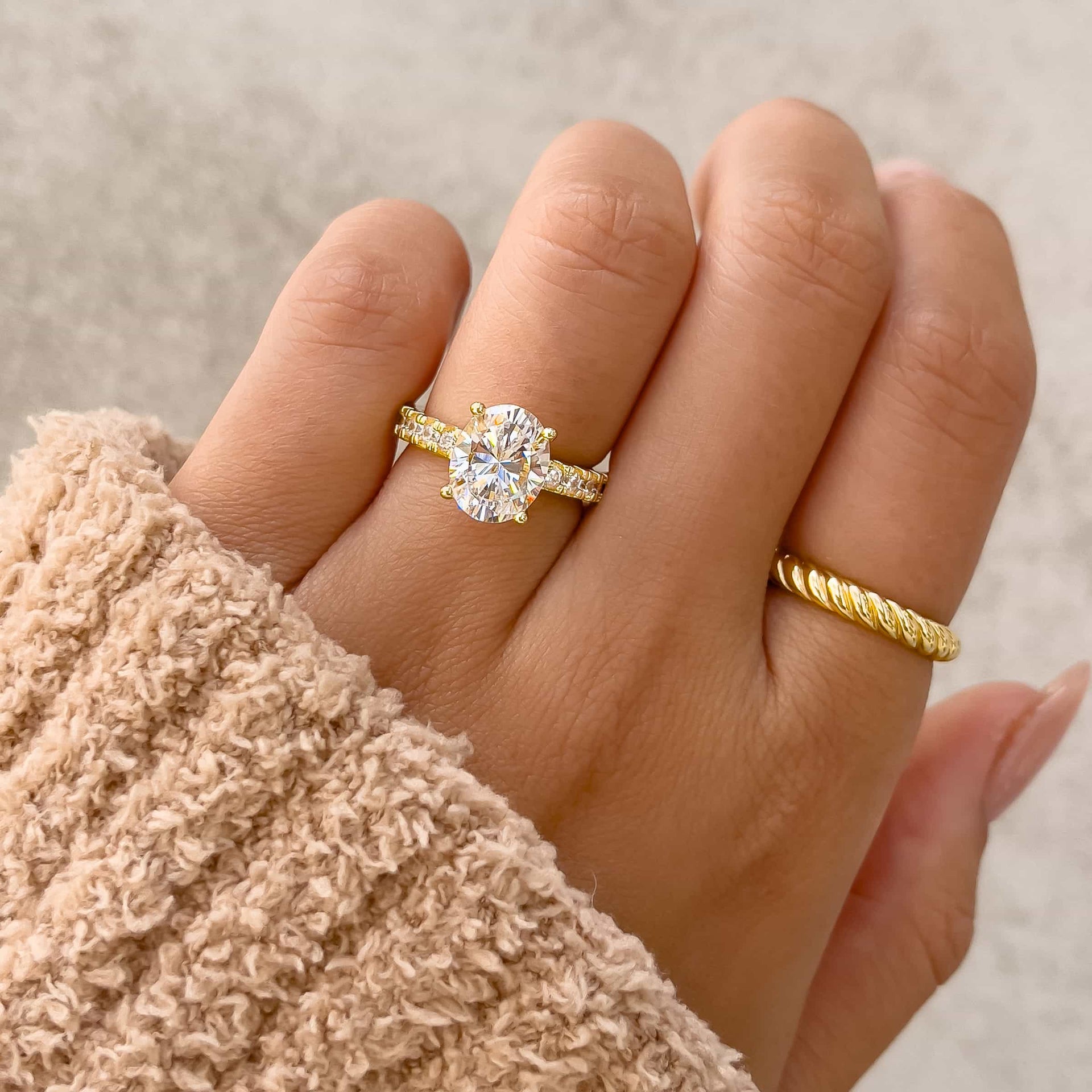 gold 3 carat oval cut engagement ring with thicker half eternity band and a rope ring  