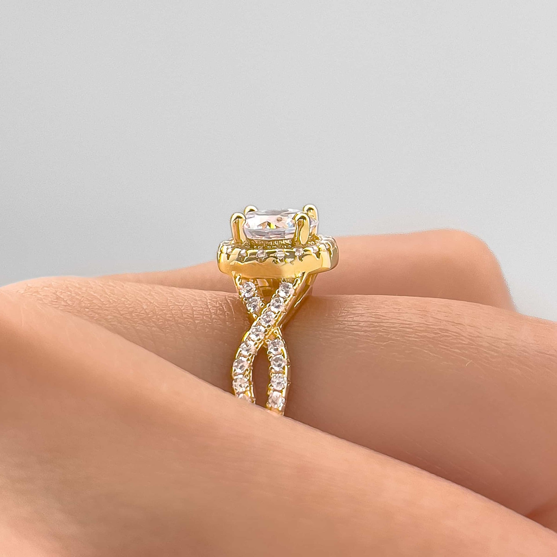 setting shot of the grace engagement ring in gold on model's finger