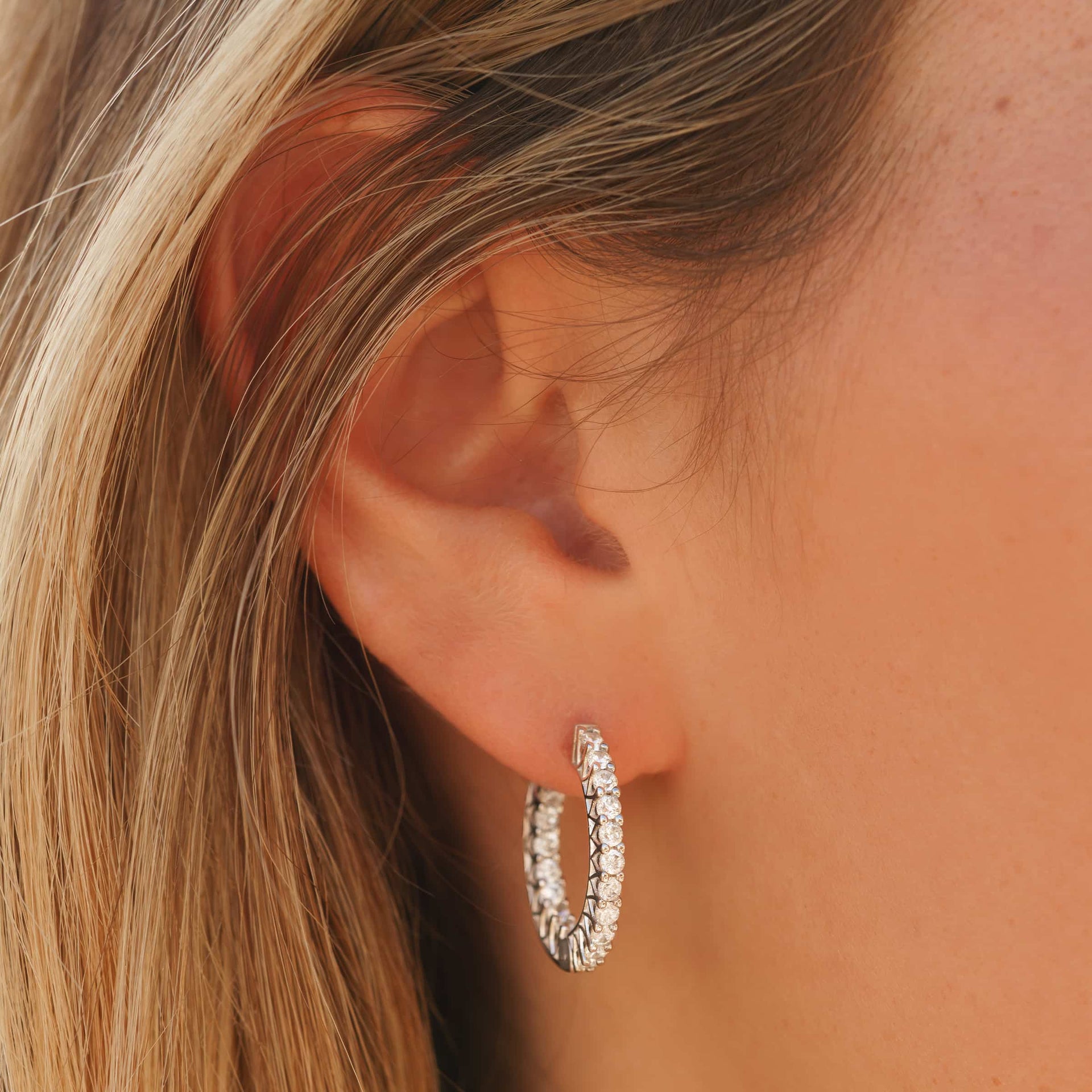 stunning silver hoop earring on model's ear