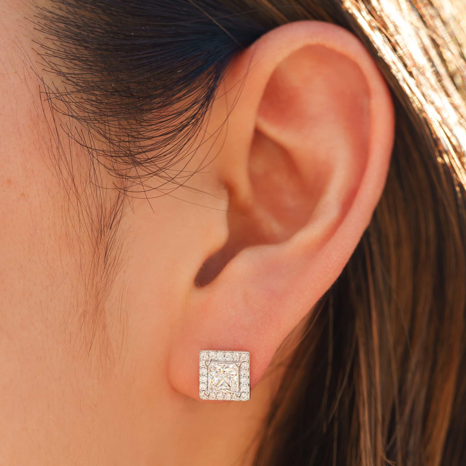 stunning silver princess cut bridal earring on model's ear