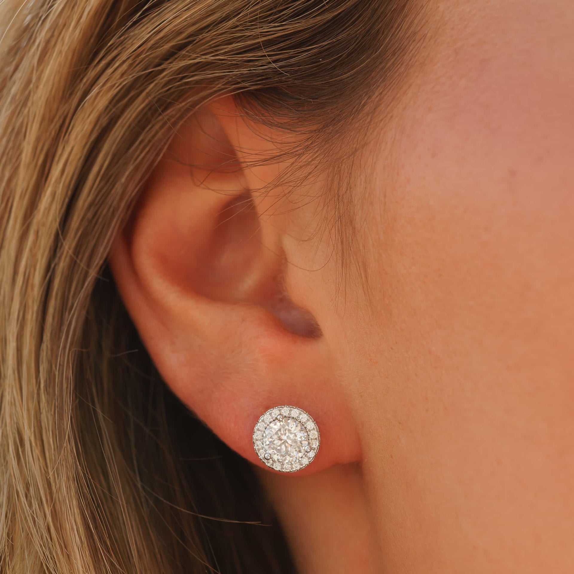 stunning silver round cut earring shown on model's ear