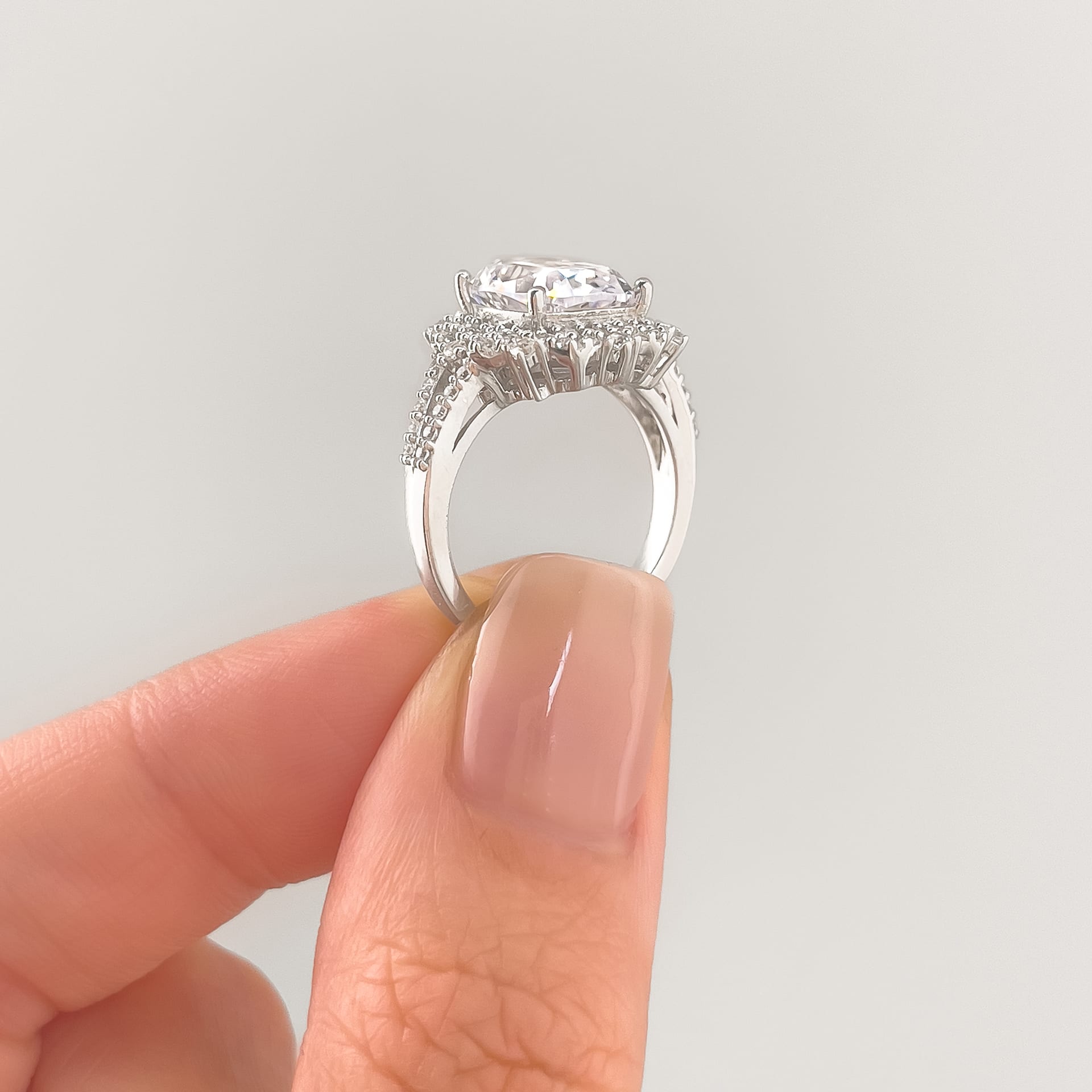 setting shot of a stunning vintage elongated cushion cut held by model