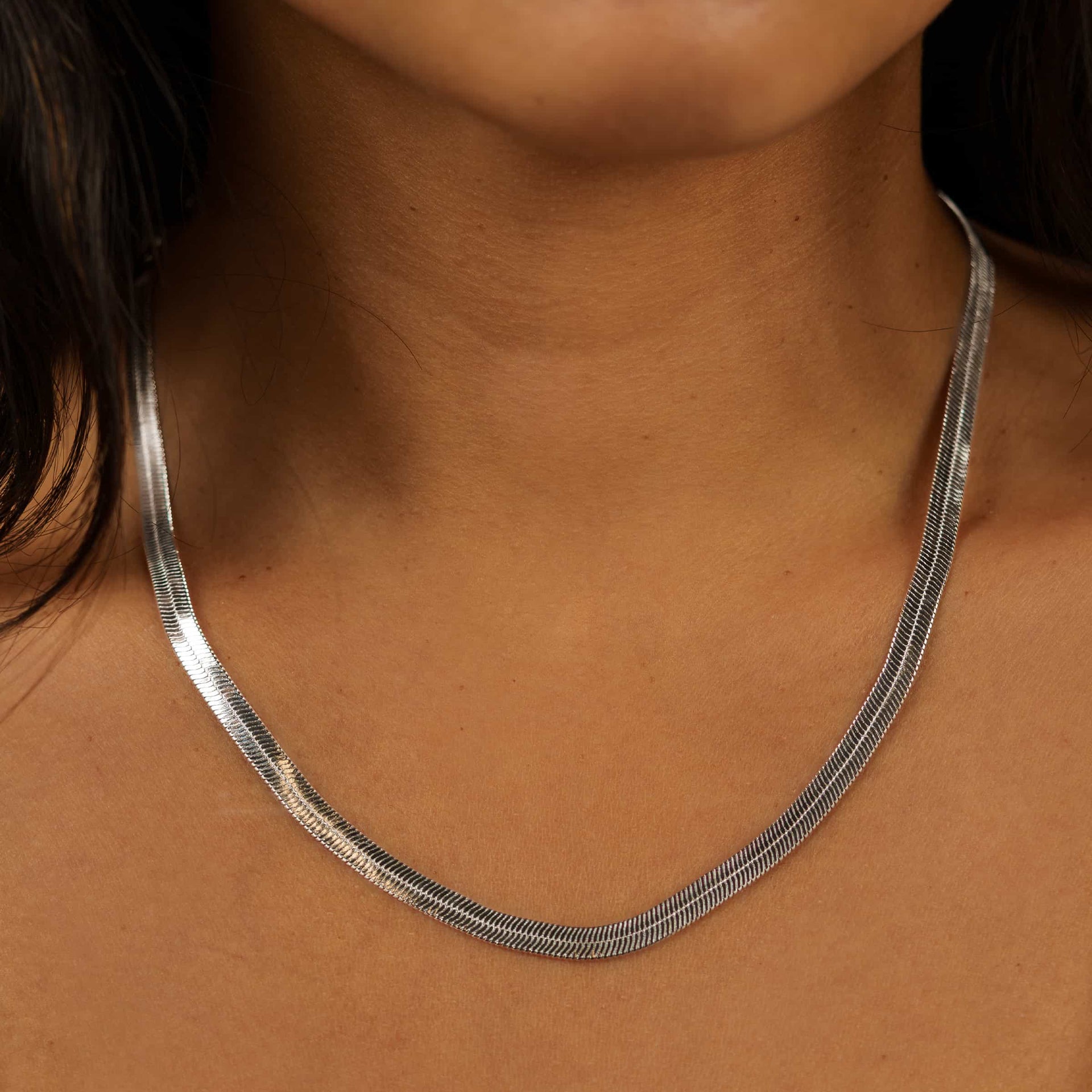 silver herringbone detail chain necklace on a model