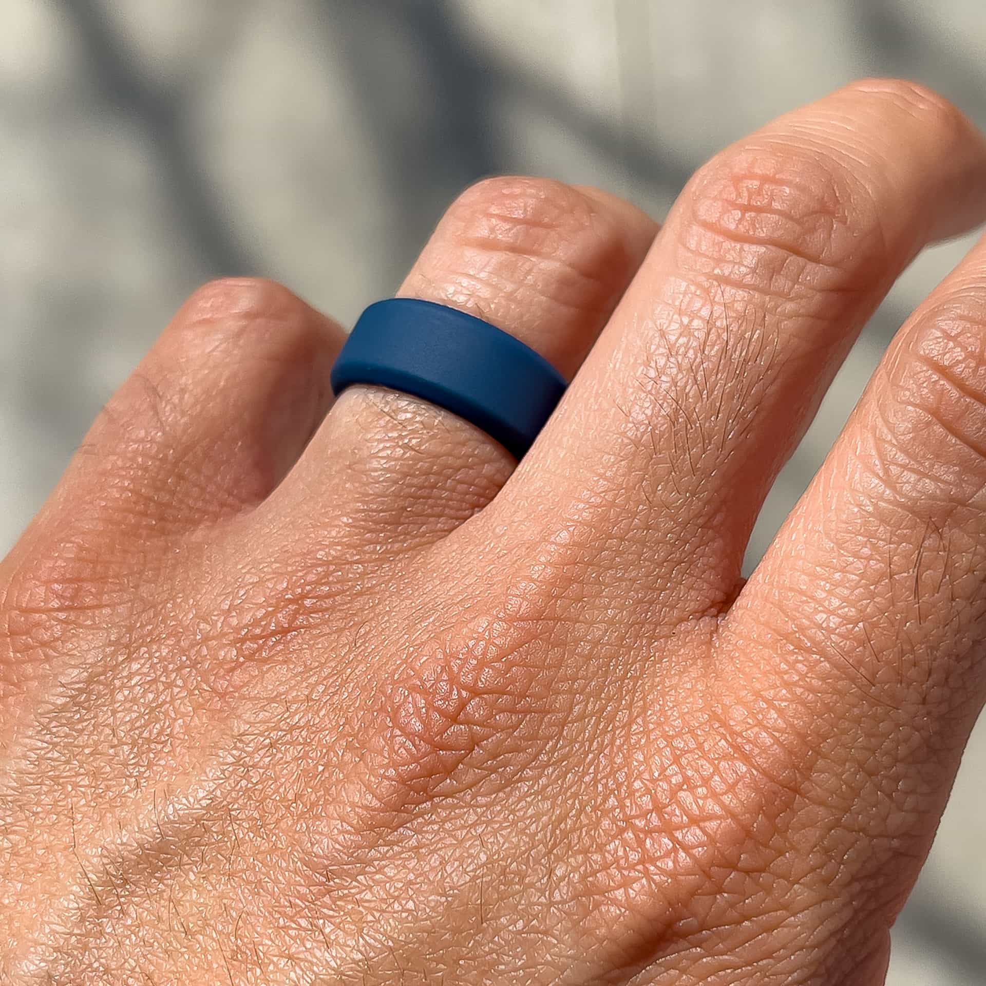 a dark blue simple silicone wedding band on male model