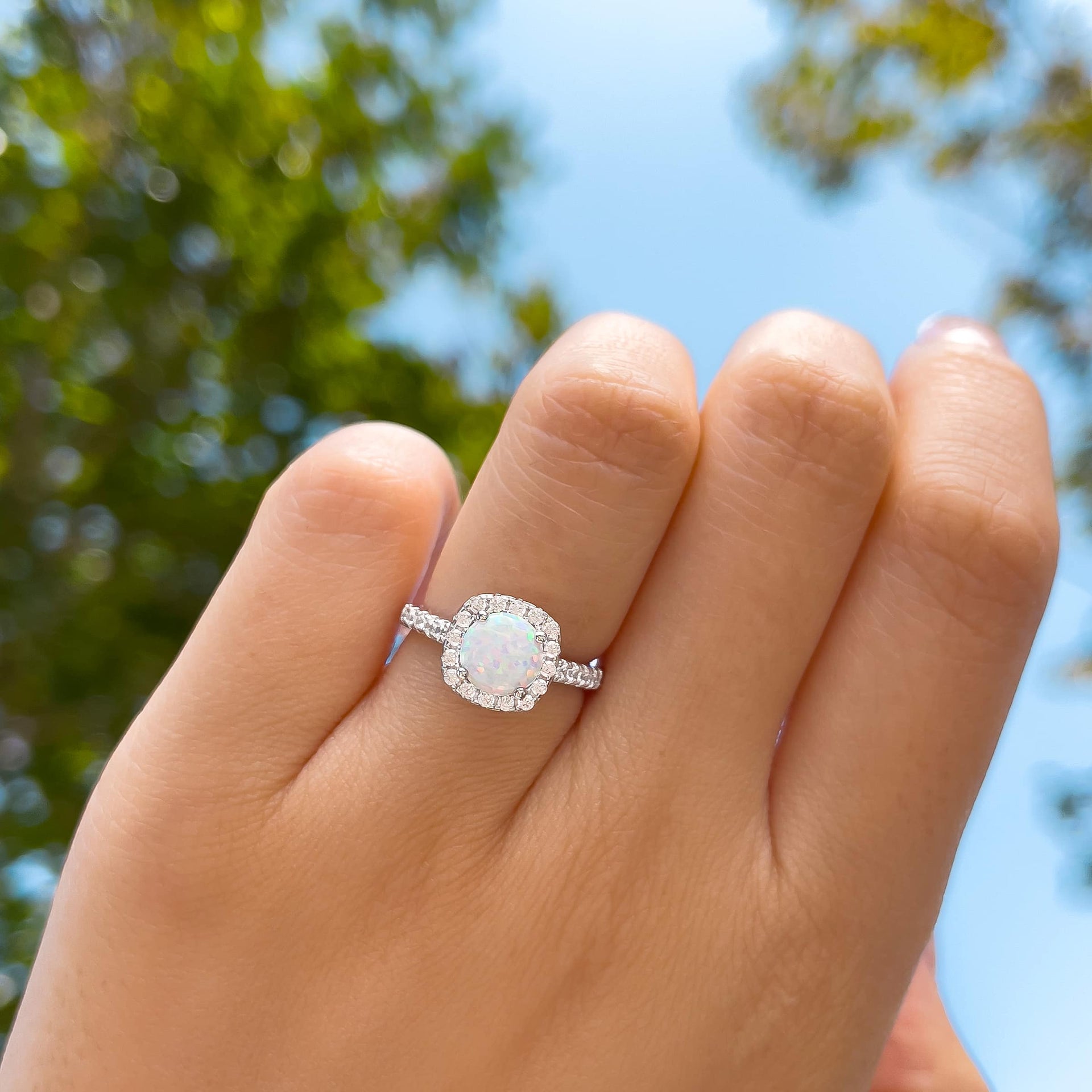 unique halo round cut simulated opal engagement ring on model