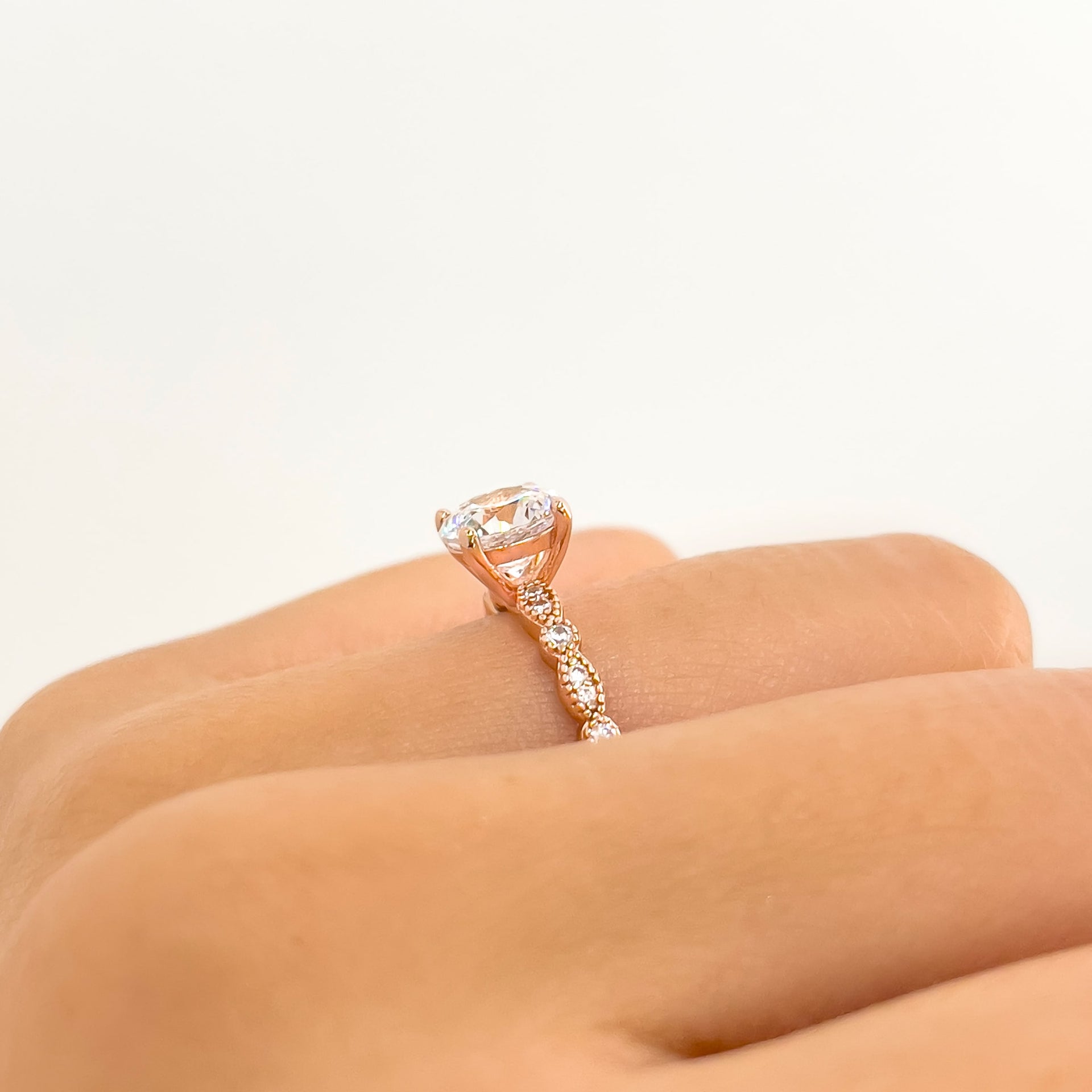 side view of rose gold round cut vintage style engagement ring