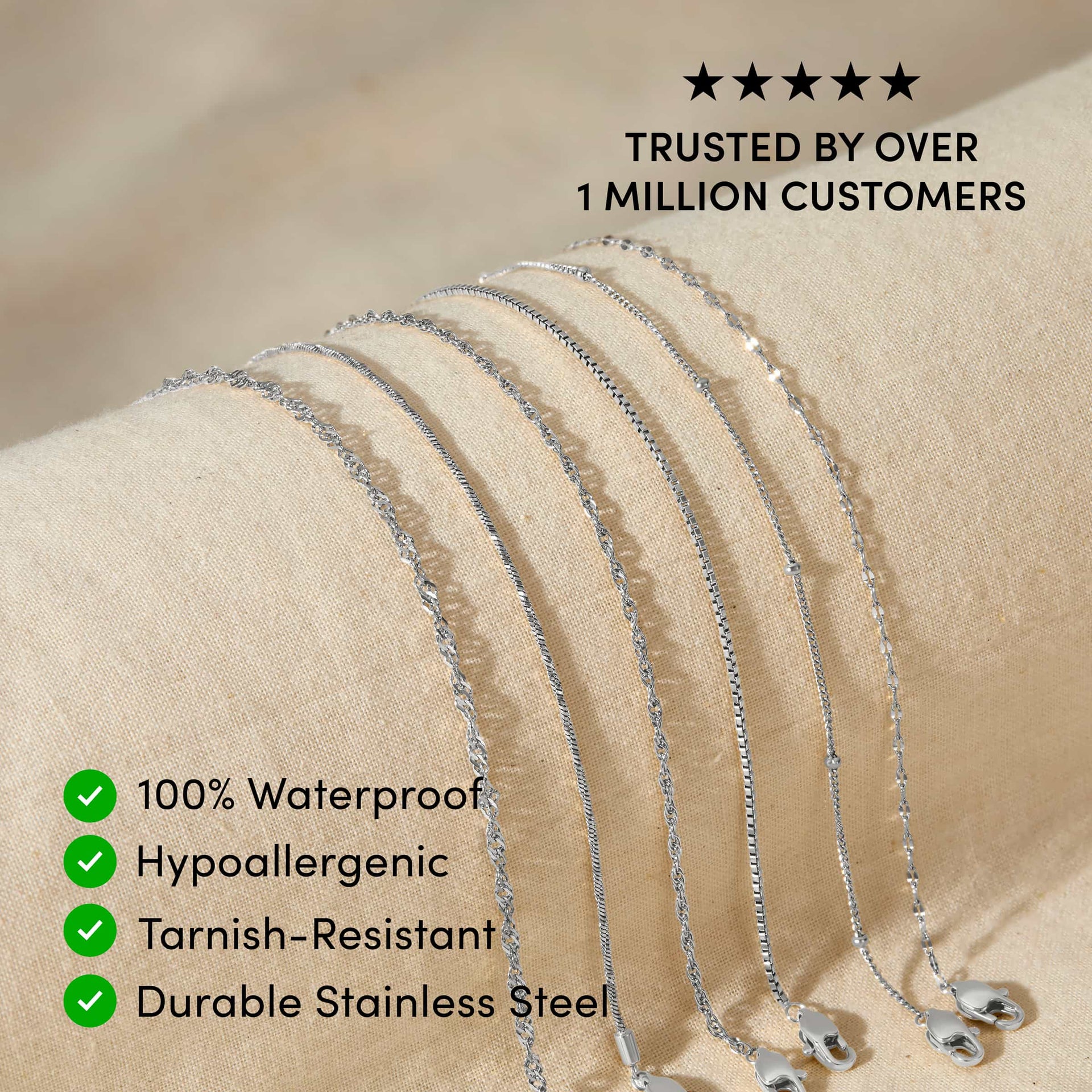 five silver stainless steel dainty chain bracelets resting across a tan surface with the text overlayed "trusted by over 1 million customers, 100% waterproof, hypoallergenic, tarnish-resistant, durable stainless steel"