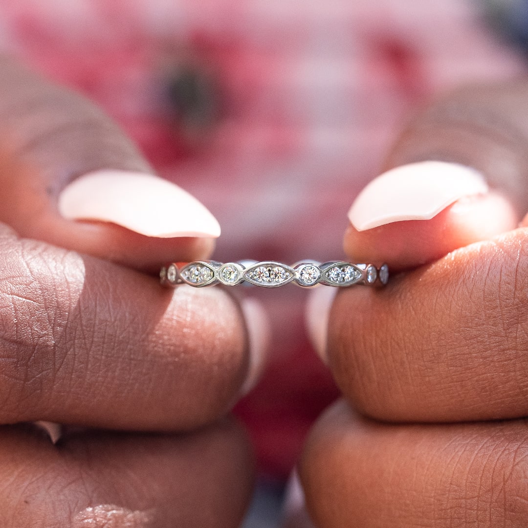 Fingers holding wedding band