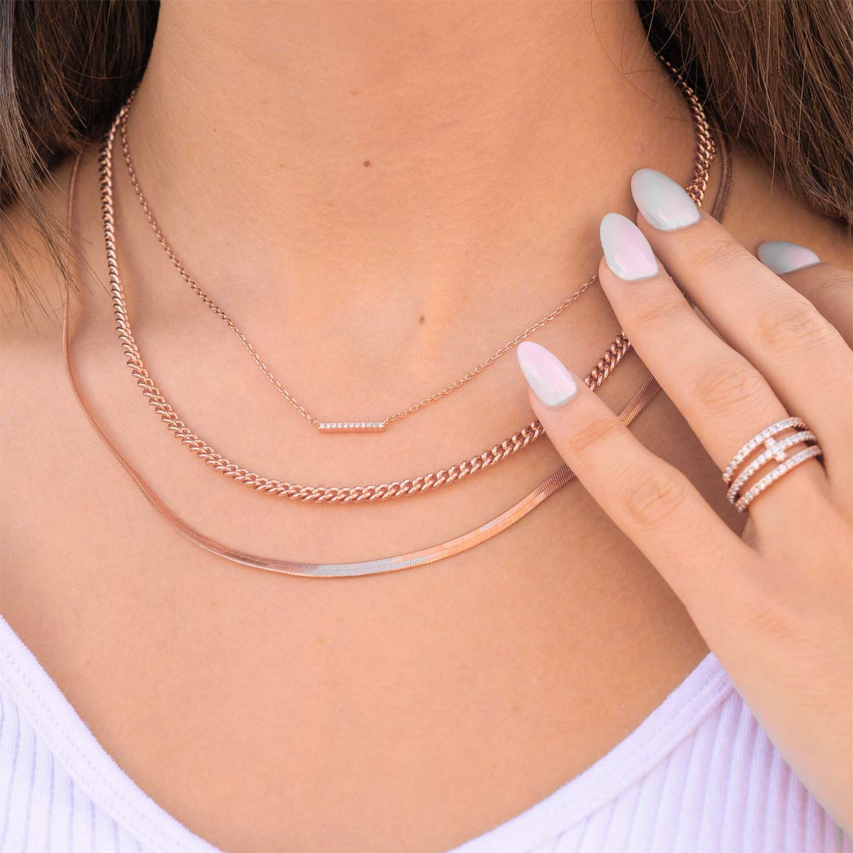Rose gold layered necklaces on model