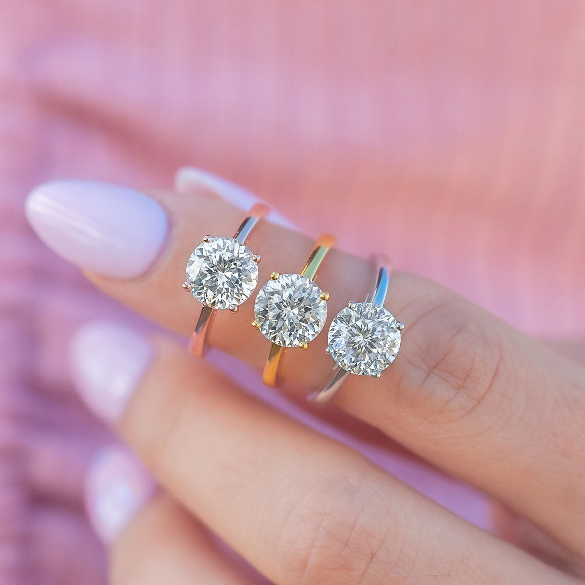 Cute round cut rings on womans finger