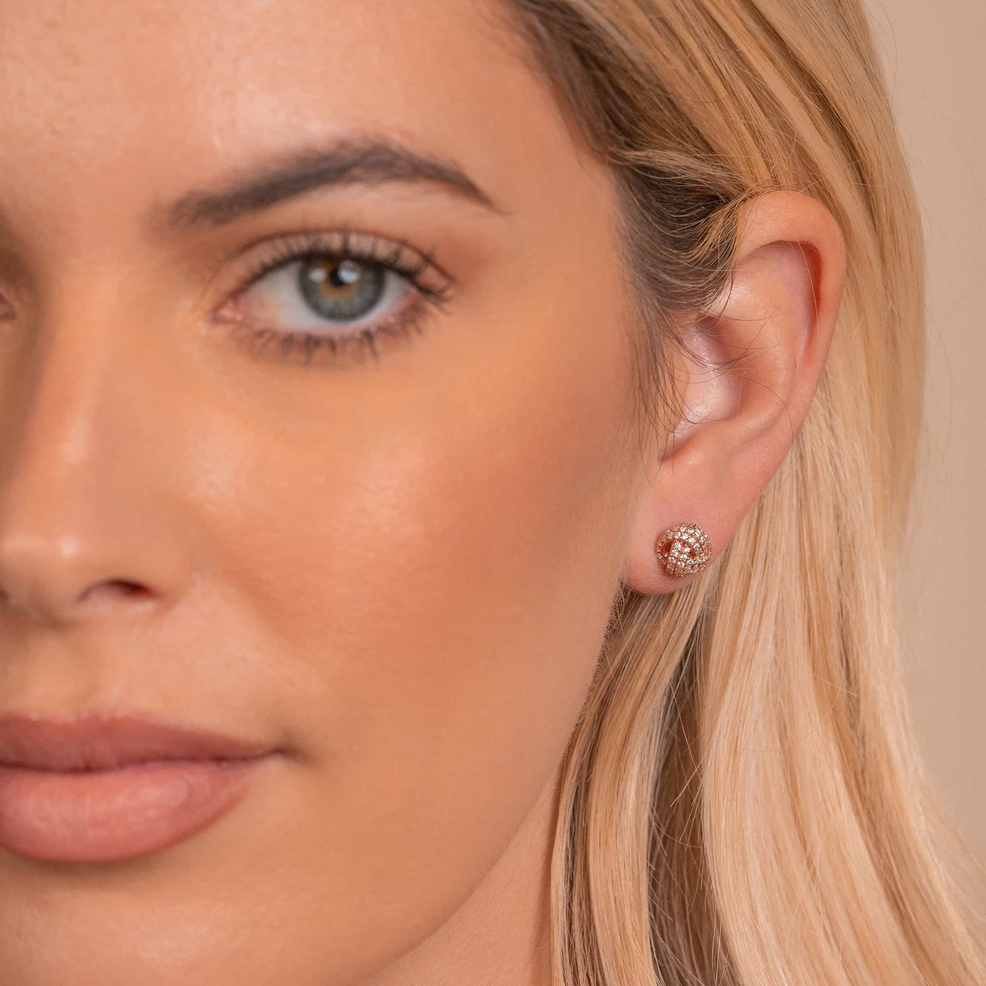 Cute bridal rose gold earrings on model